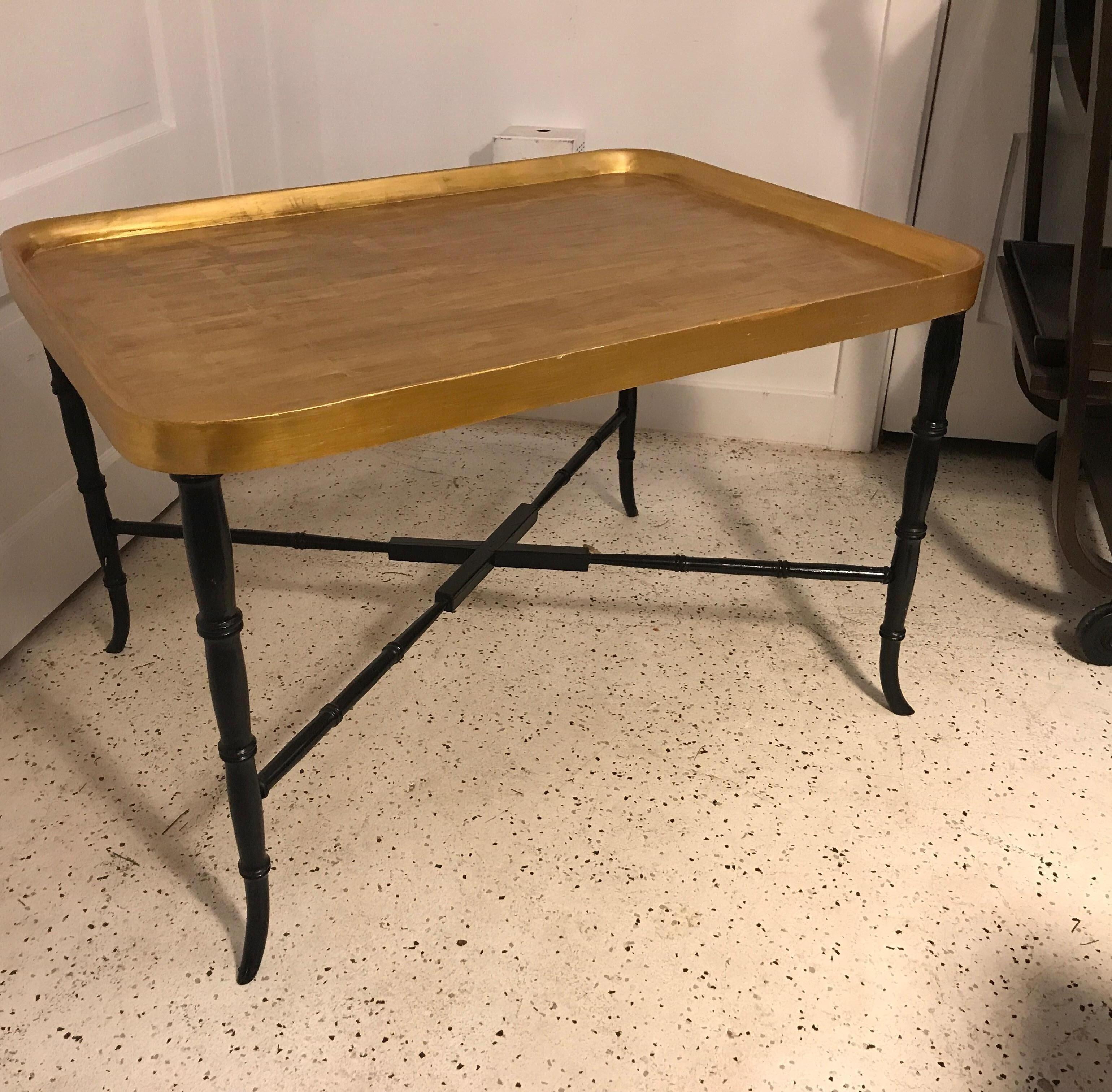 Elegant gilt topped tray style table with ebonized legs. The tray top is attached and not removable. The base with faux bamboo style legs with stretcher base. Very chic and Classic design, Italy, 1960s.