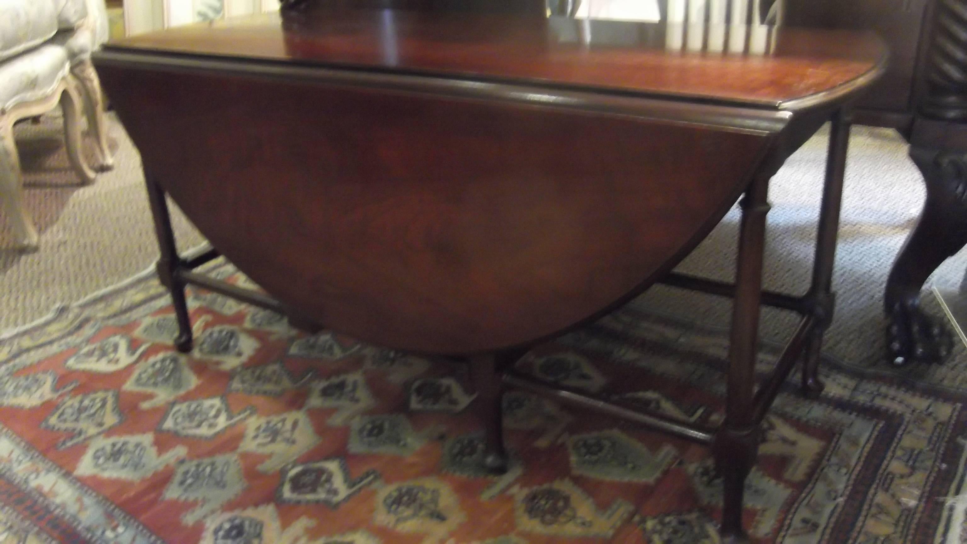 A versatile solid mahogany gate leg cocktail table. Made by one of the premier American furniture makers Baker.  A perfect table when you want something not to large but want the option of a much larger table for entertaining.  Beautiful graining,