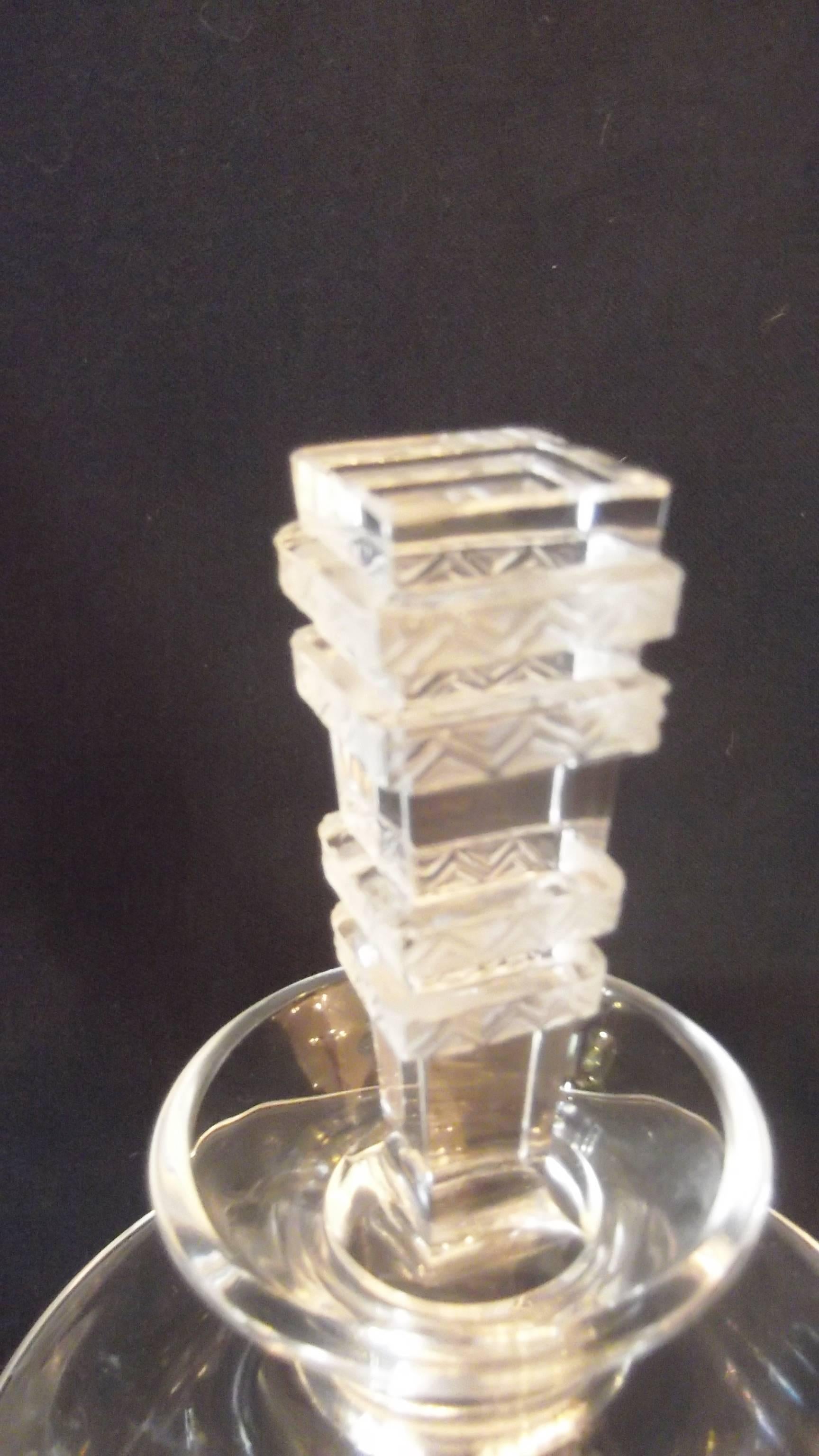 Beautiful pedestal Lalique decanter.  Neo Classic shape with Deco style stopper.  Clearly signed Lalique France on square base.  This piece is no longer in production and hard to find.   