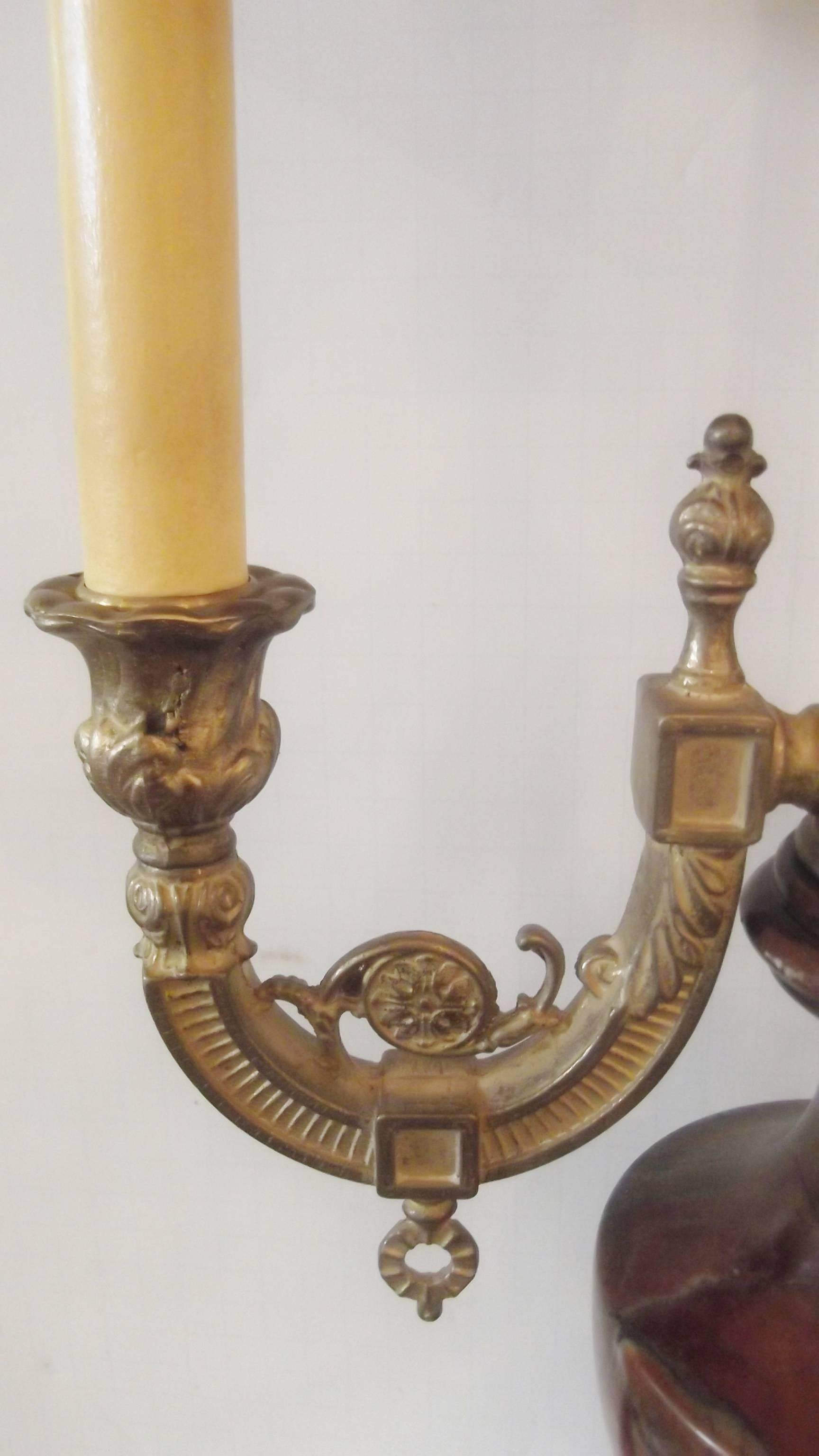A Decorator lamp with 2 lighted arms.  Classic marble urn body resting on a pedestal base.  Gilt brass arms with tall gilt spire center.  Extra bright for a desk lamp with the double lights,   Paired with 2 nice pleated shades. 