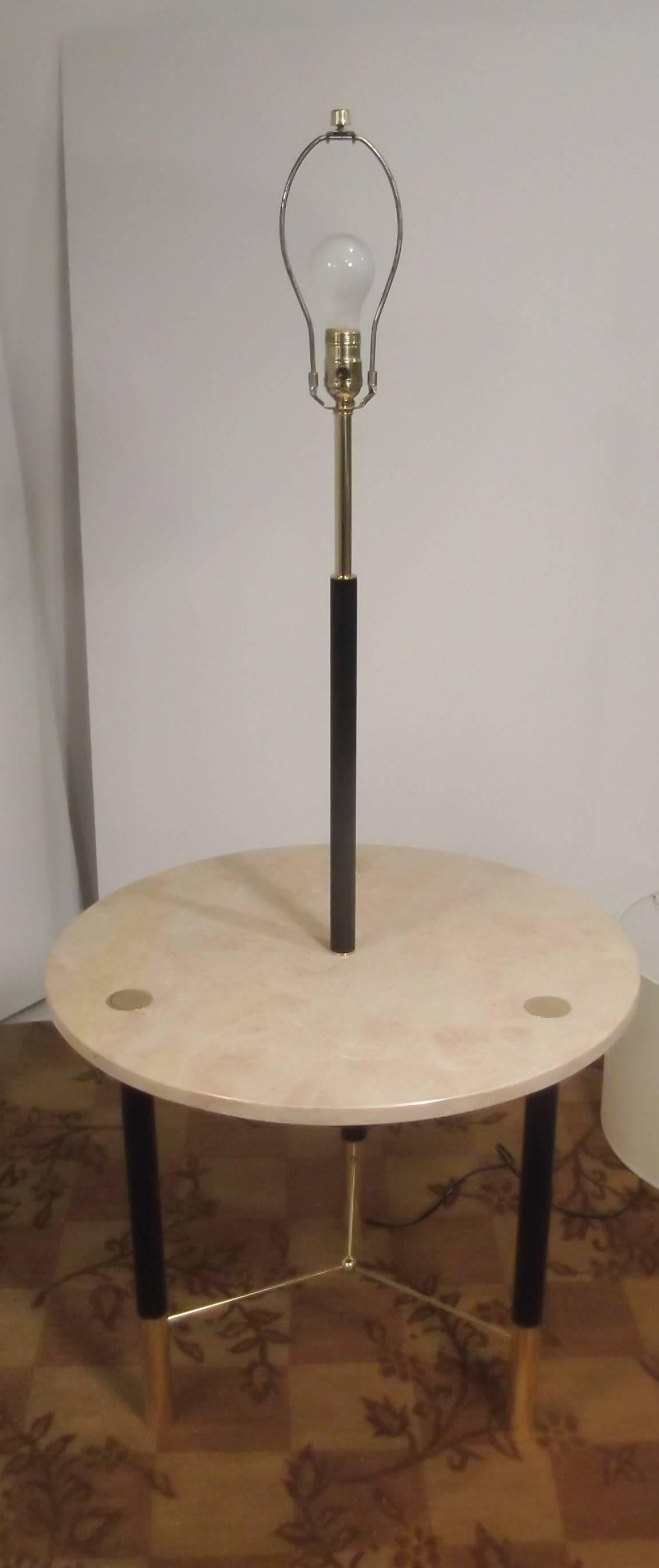 Authentic Harvey Probber marble top floor lamp with table.
The round marble top has polished brass "buttons" that anchor the ebony legs. The lamp portion is newly rewired and new lamp hardware, ready to use. The shade is for photographic