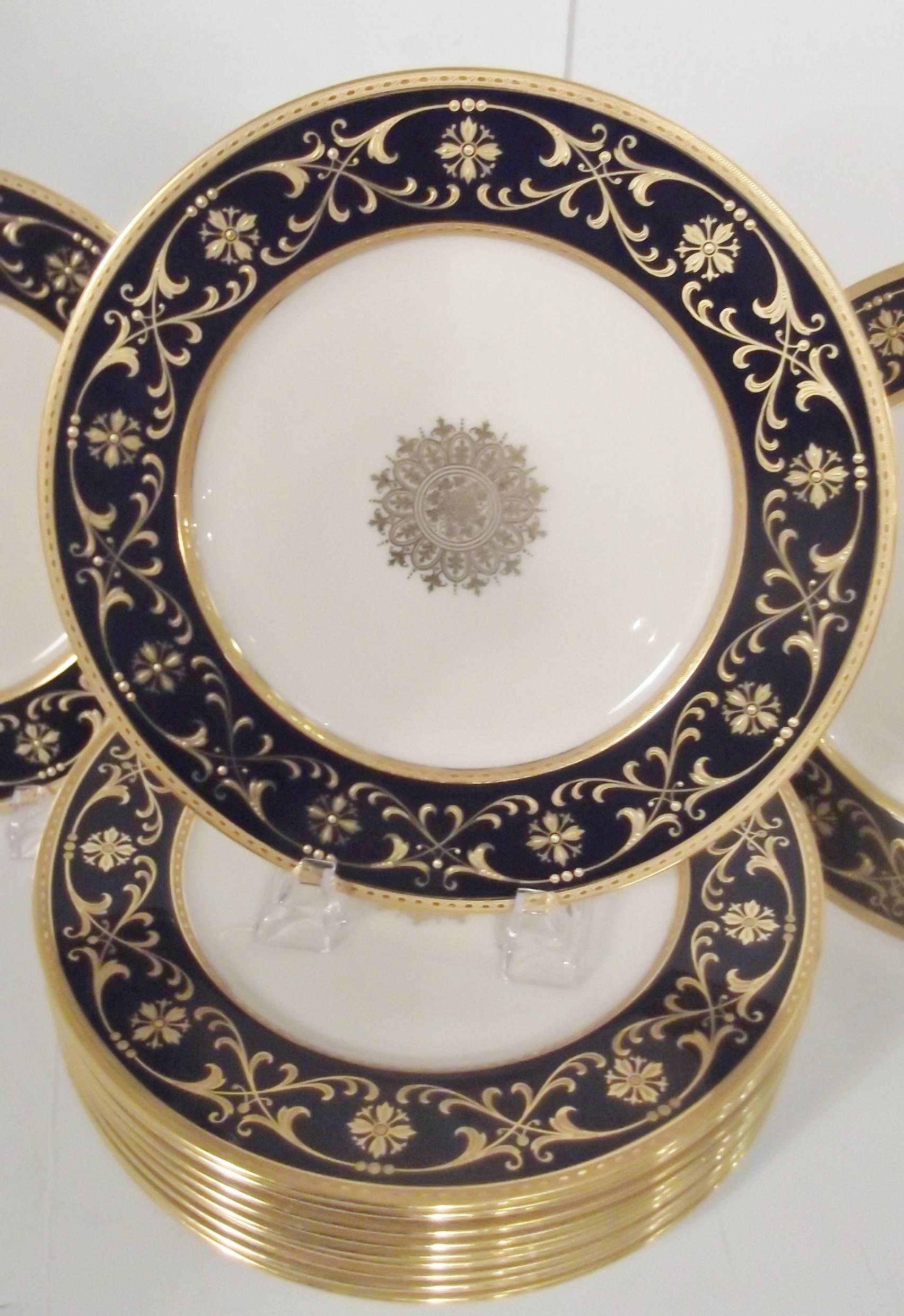 Elegant set of 12 cobalt and gilt border service plates.
Beautiful center medallions with raised textured gilding and inner and outer gold rings. Made by Lenox with the early green mark. These plates have a year mark of 1937 along with the