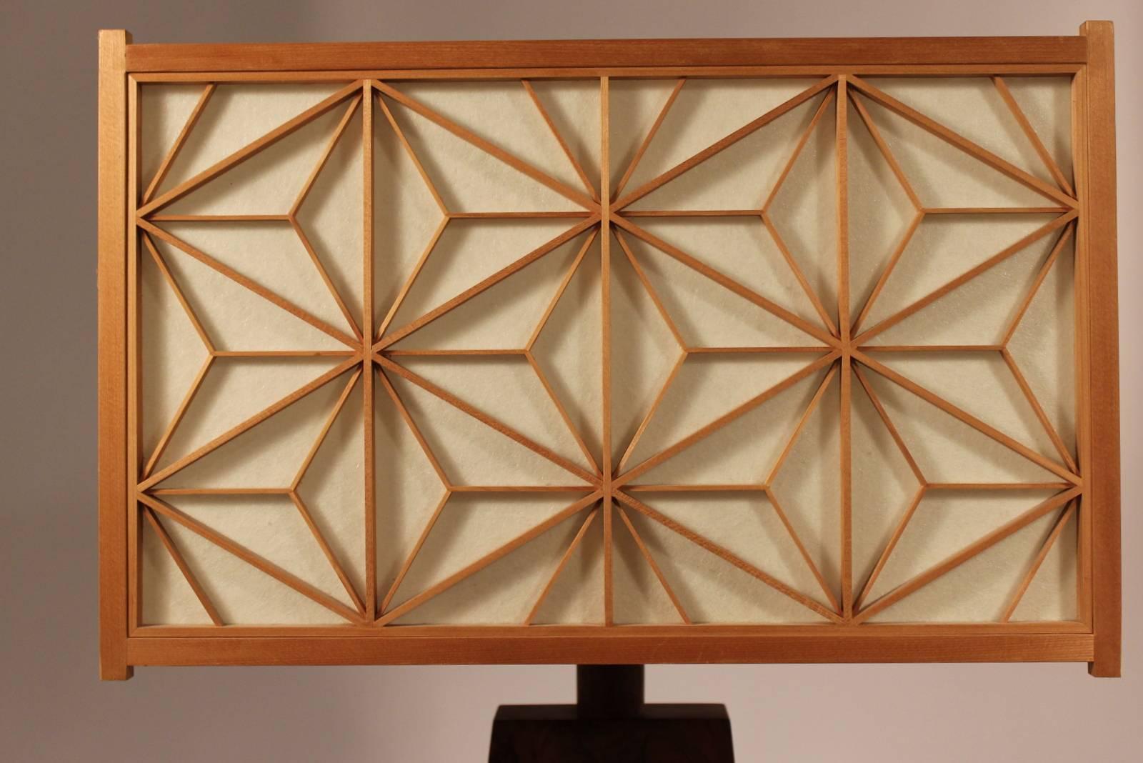 Mira Nakashima walnut table lamp. Signed on bottom, authentic.
The panels on the shade were made in Japan, according to Nakashimas direction. It is a very complex pattern in which 12 pieces of wood must intersect at specific points, and requires