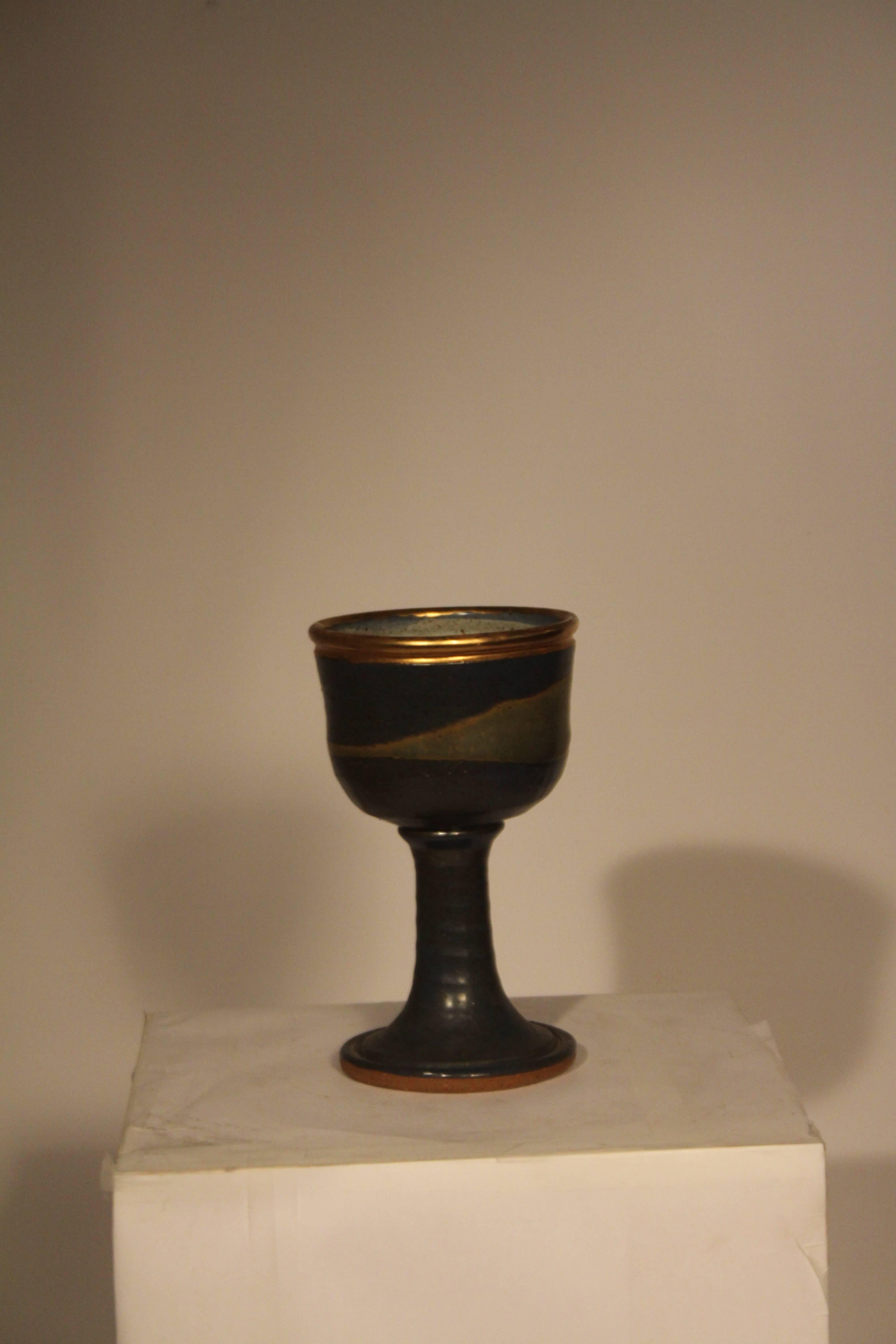 Large stoneware Chalice with blue/purple glaze and a gold luster rim. 
Signed with artists cipher. Possibly one of a kind, 1960s. Temple’s 
Pottery is in many museum collections internationally. He was part of 
the New Hope Studio School of
