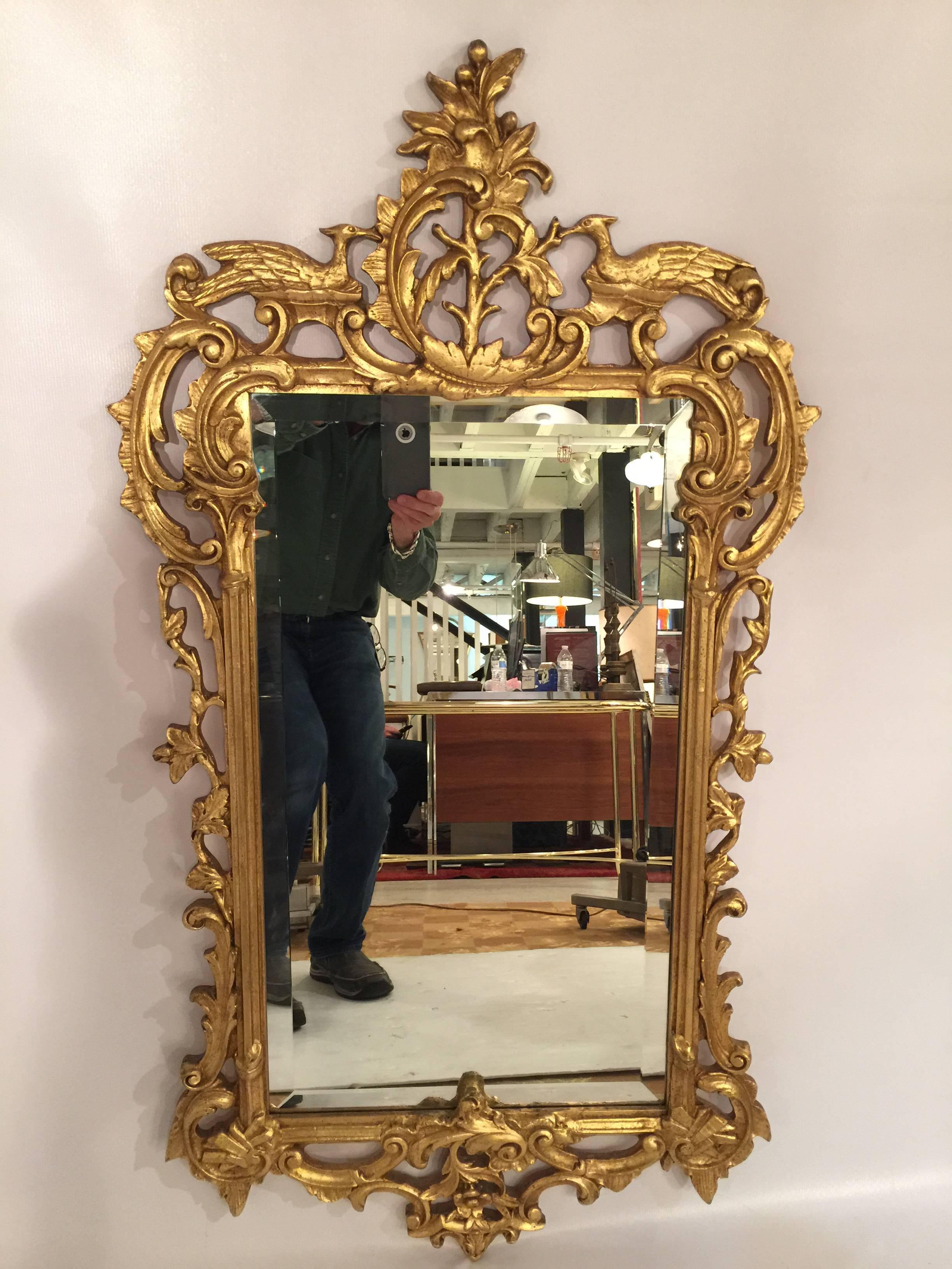 This hand-carved gold gilt mirror from the 1940s was made by Friedman Brothers Company. One of the premier mirror makers.
Has a nice beveled mirror in excellent condition.