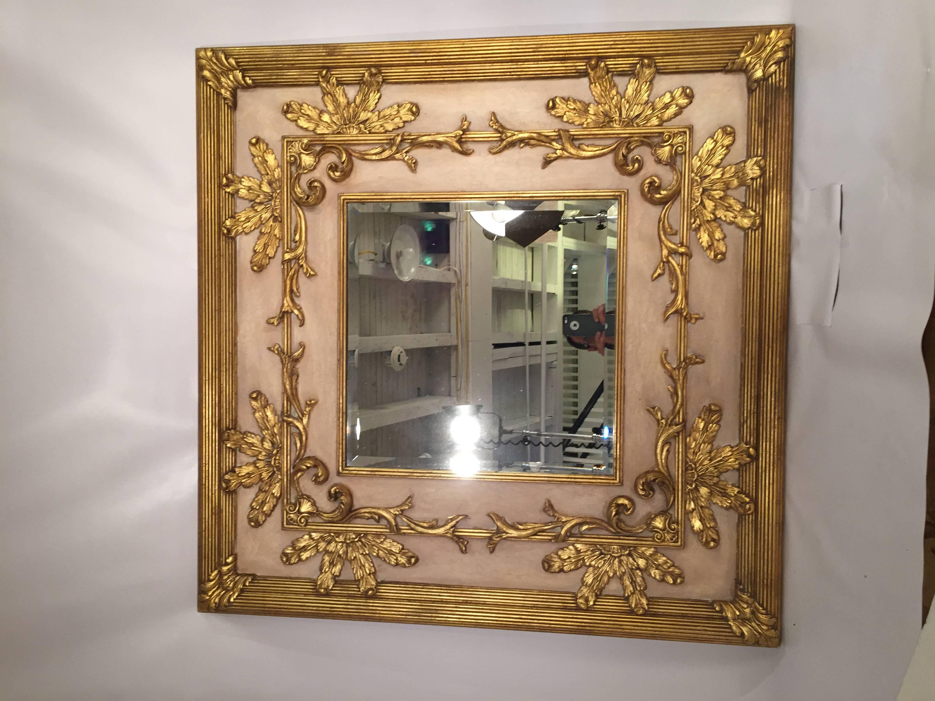 Opulent gilt and beveled glass mirror made by the premier mirror maker Friedman Brothers. Louis XV style with a flesh toned background accented by gilt scrolls and acanthus leaves. The outer reeded frame surrounds a 12.5" think generous frame.