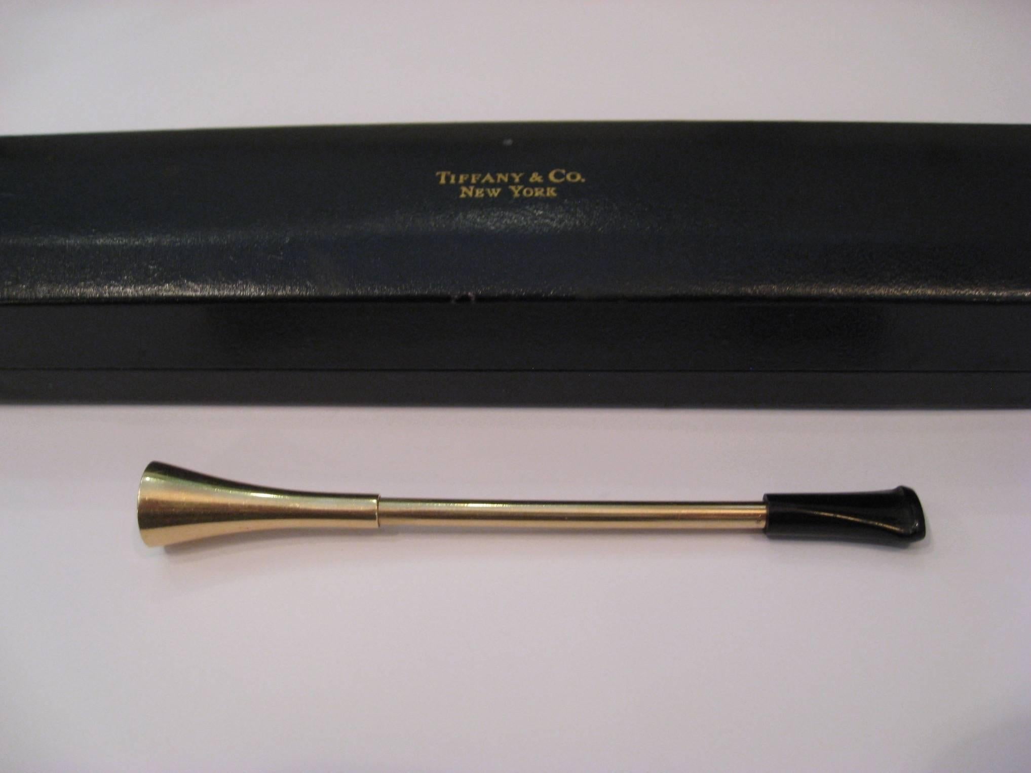 Mid-Century Tiffany & Co 14-karat gold cigarette holder with bakelite tip. Excellent condition with normal wear and light surface scratches. This has a spring mechanism to eject the cigarette from the holder. Engraved with Tiffany & Co 14K