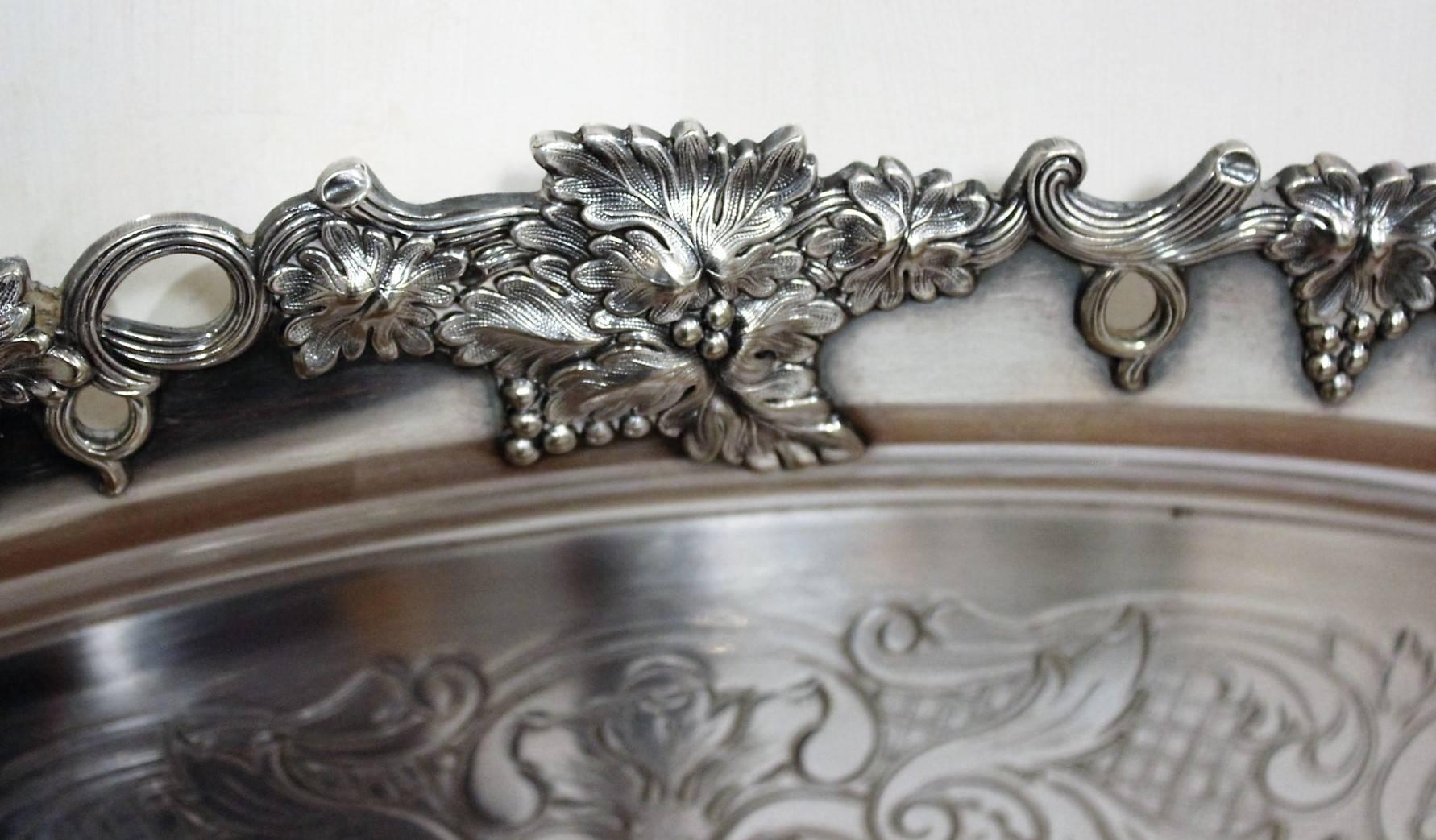 Antique English engraved waiters tray with pierced edge. Beautifully cast handles with engraved tray surface. This tray was made in England for the Gorham silver company and marked England and Gorham, the markings on the back date to  Circa