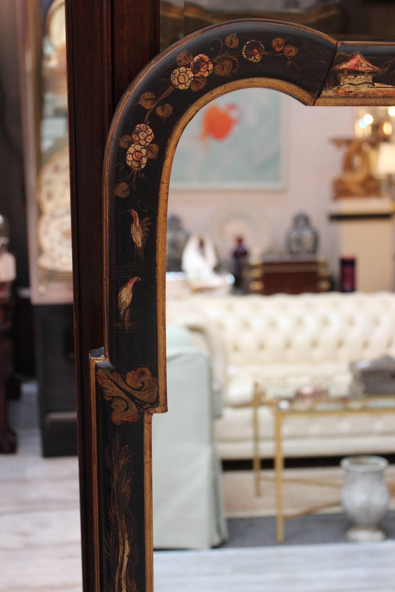 Chinoiserie wall mirror with hand-painted decoration on a black background. Made in Italy in a classic chinoiserie pattern, this mirror is a slightly narrow version of a timeless design. All original and in excellent vintage condition.