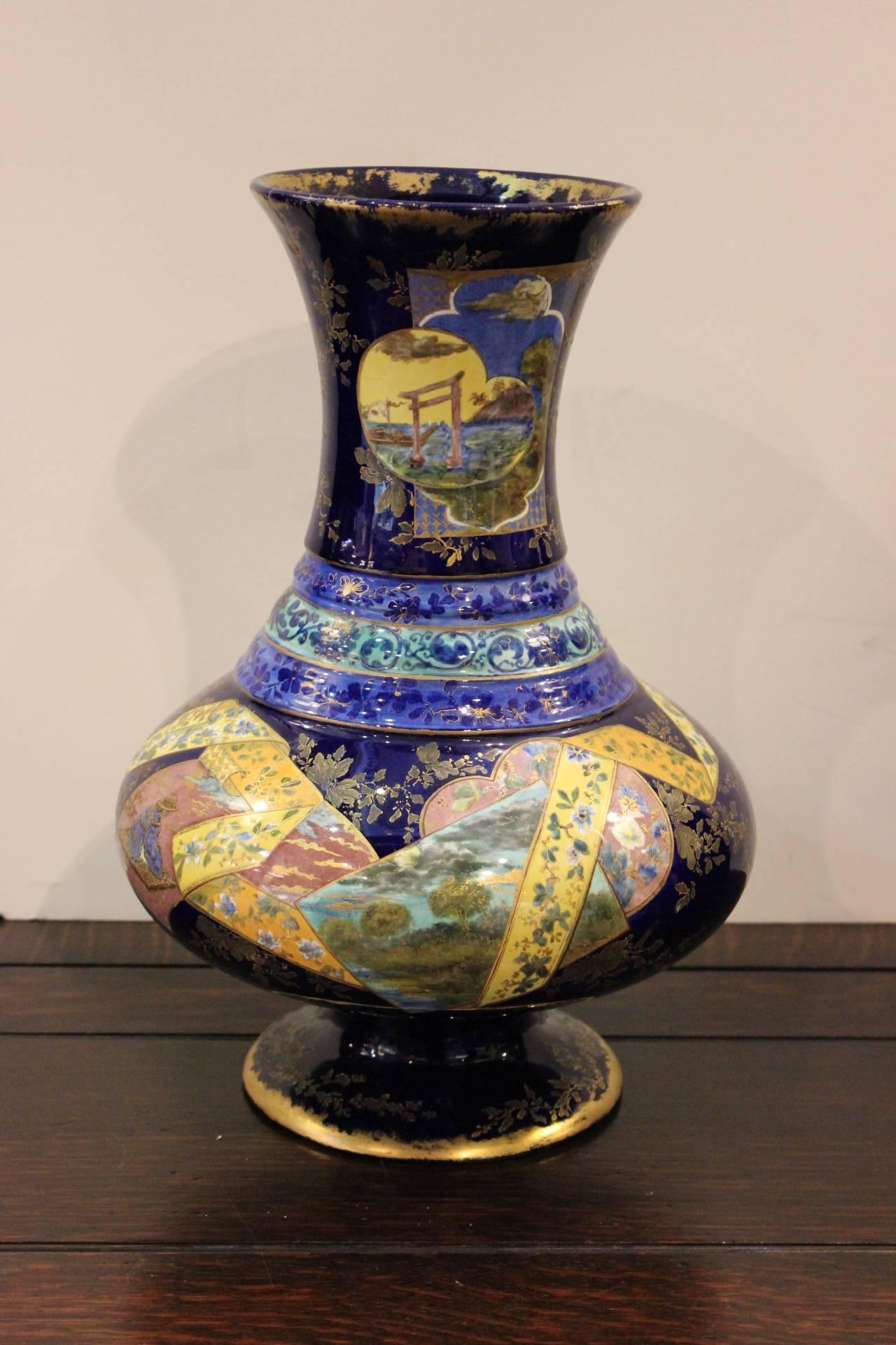 Exquisitely painted French faience chinoiserie bulbous pedestal vase. The intricately painted body in vibrant Asian motif with a cobalt background. Subtle gilt highlights on the top and base.