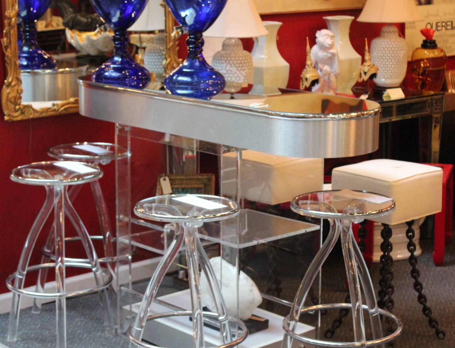 Lucite bar with mirrored top and chrome mounts by Hill Mfg.
Hill is known for best of the best Lucite furniture and fixtures and their designs have become iconic and collectible. The bar is in excellent original condition with minimal wear.