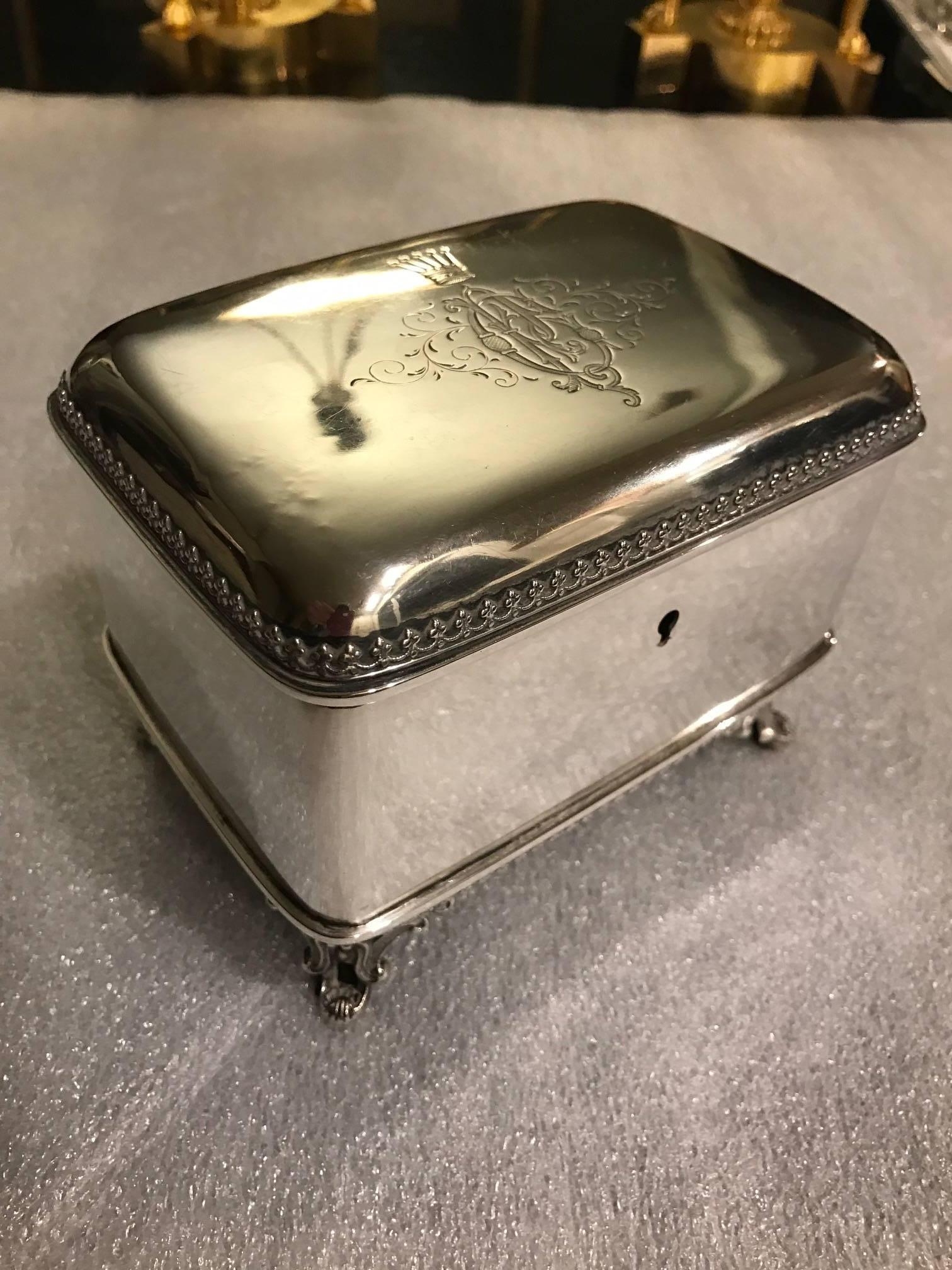 A late 19th century Austrian 900 silver table box with hinged lid. The rounded corners with a beautiful hand engraved monogram with crown of a highly stylized ‘C’ intertwined with a ‘P’. The feet are cast silver with delicate scrolling. The sides of