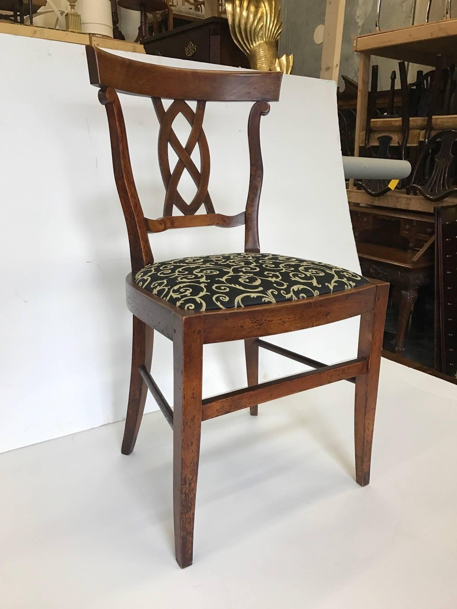 A pair of walnut side chairs with pierced splat backs, hand-carved. Clean and simple lines, new back and gold upholstered slip seats.