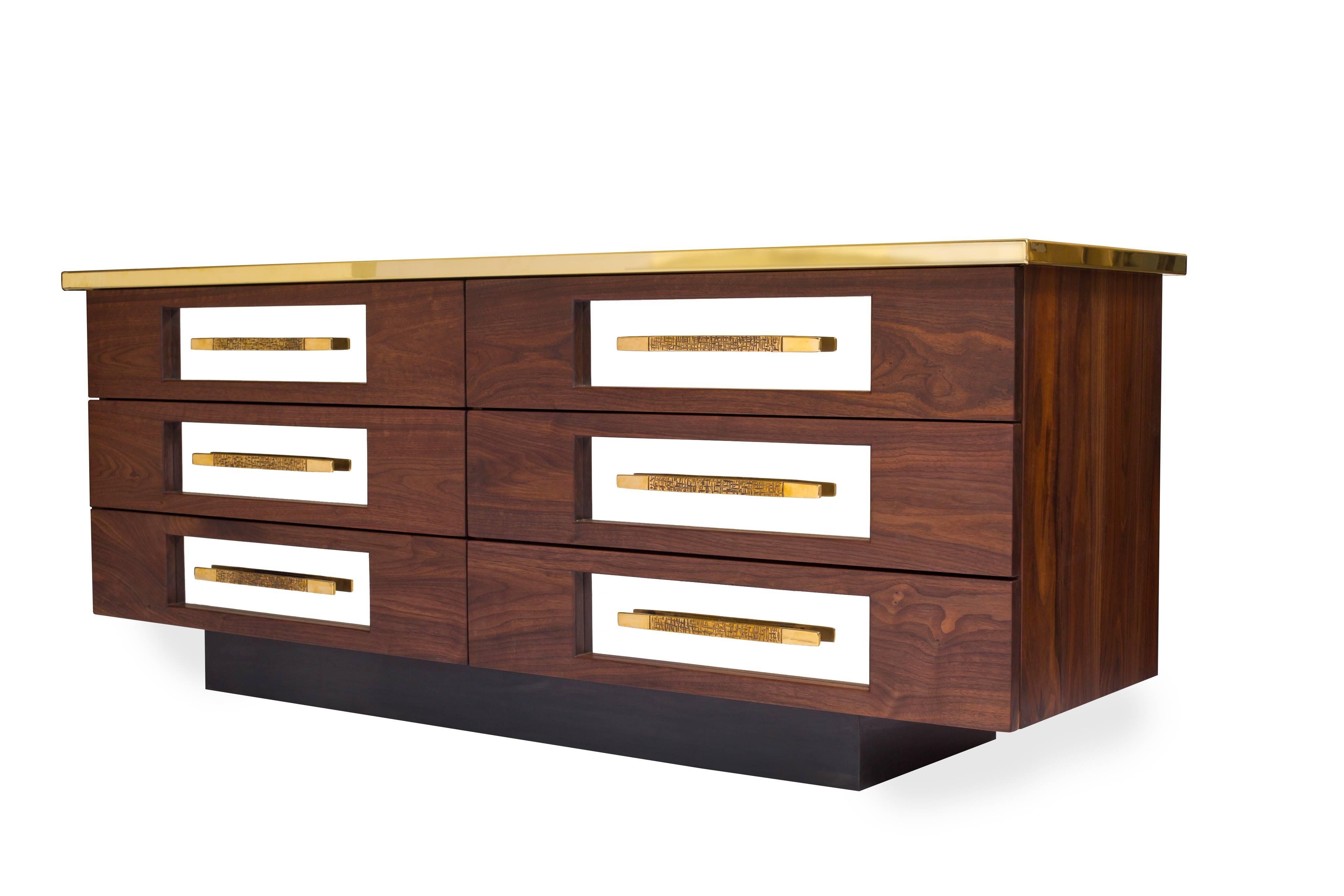 Called the " Trophy Sideboard " 

All black walnut hardwood construction with mirror-finish brass top. Also features mirrored stainless steel drawer fronts and hand-forged brass pulls. Blackened steel base.

Bret Cavanaugh is a modern