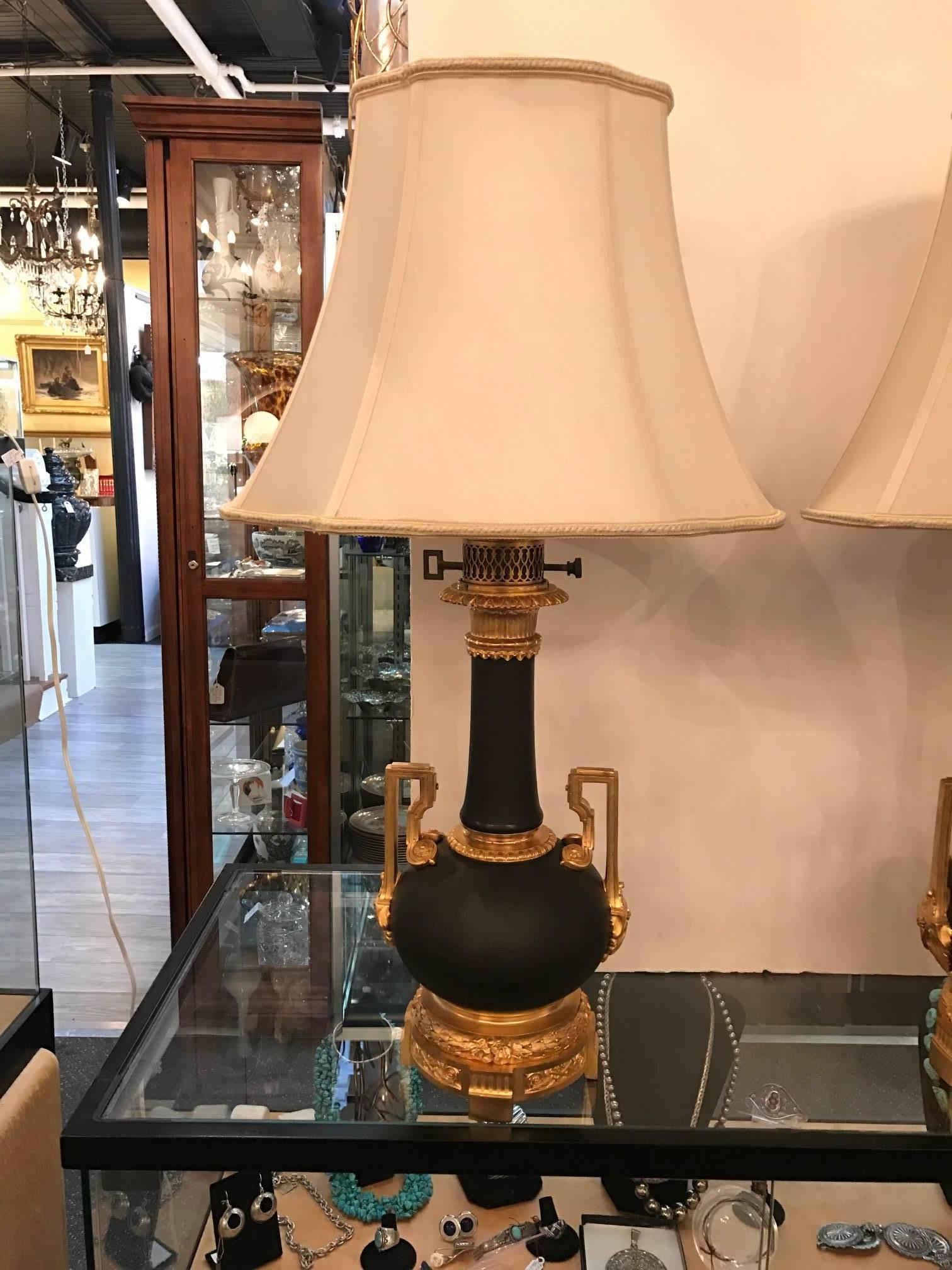 Exquisite pair of French oil Lamps now electrified. The patinated bronze bodies with slight braided texture with cast bronze gold plated mounts, made by the famous Bronze maker Gagneau in Paris on 115 Rue Lafayette.
The lamp is 18 inches high to