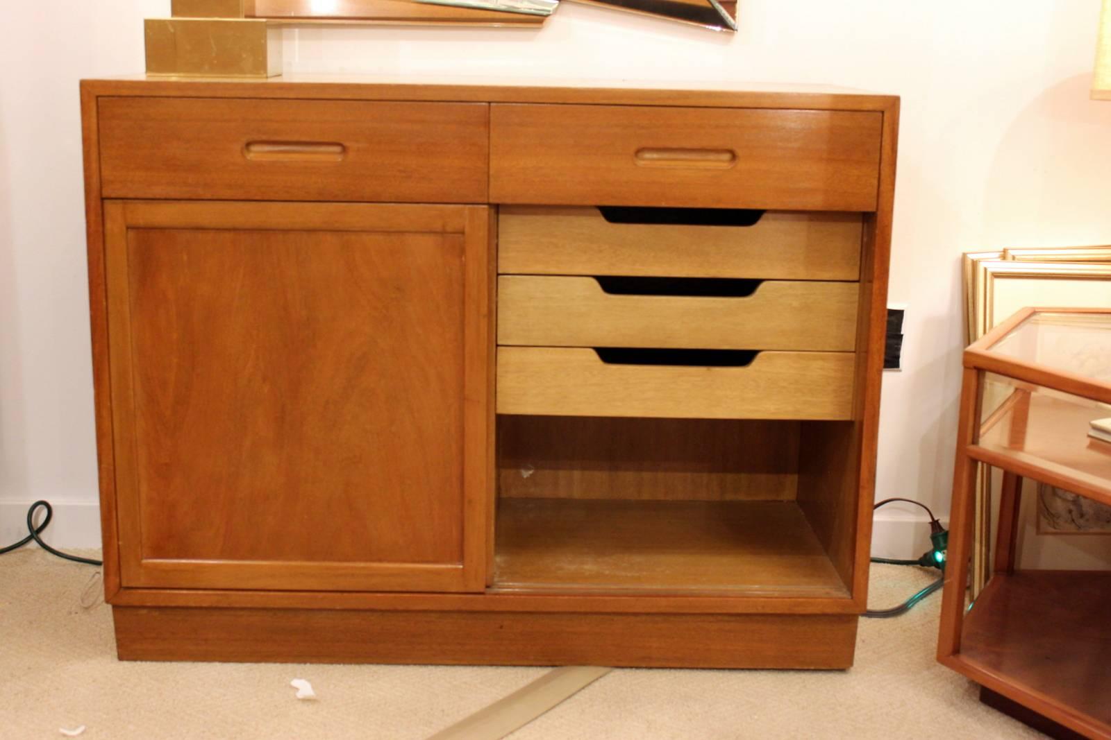 Beautiful Early Edmond Wormley for Dunbar mahogany server with two drawers over two sliding doors.