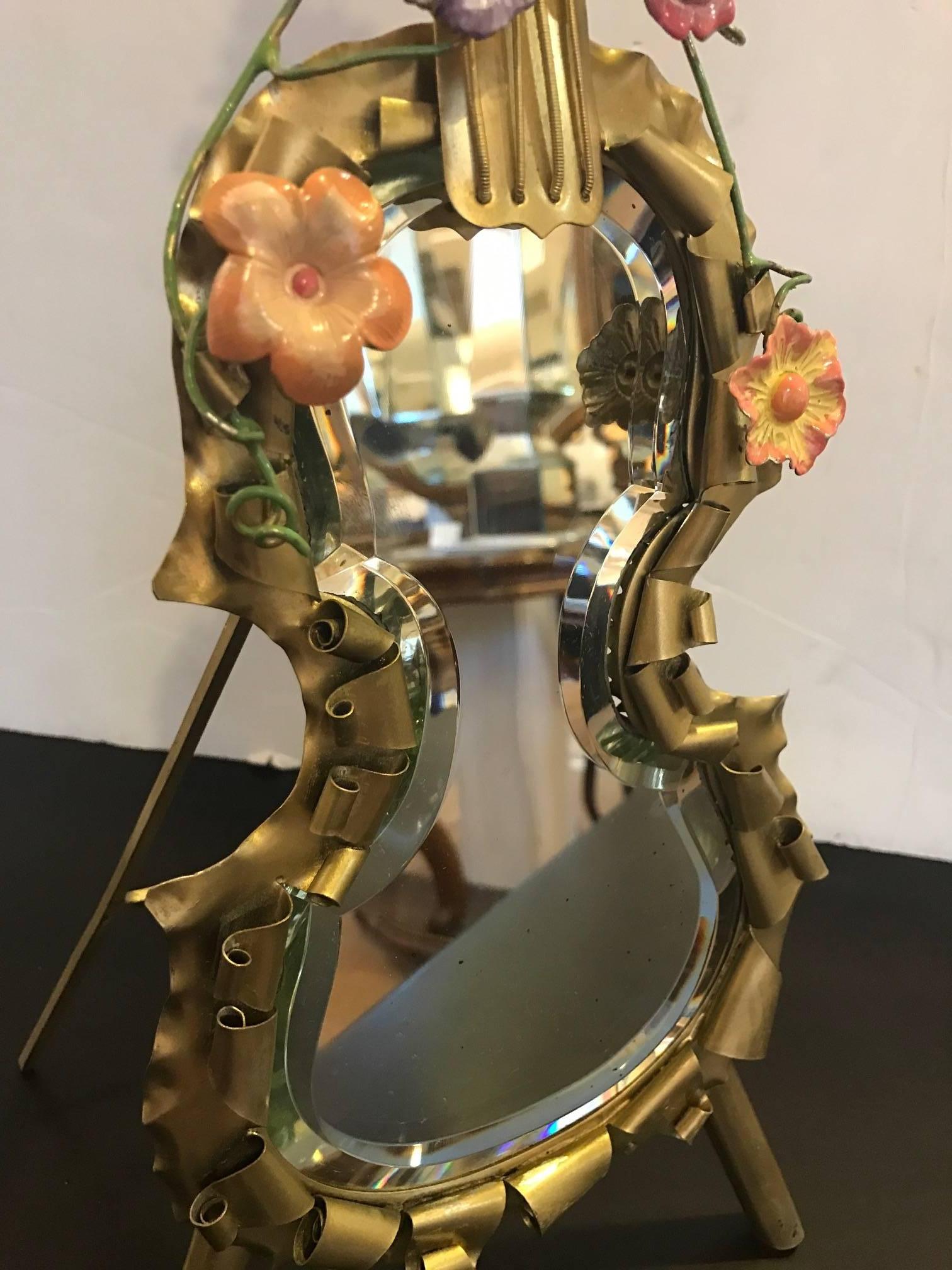 Whimsical violin motif standing mirror. The handmade frame with gilt brass covered in hand-turned curls and enameled bird and flowers applied to the frame.. The hand beveled mirror is original and has very minor age spots.