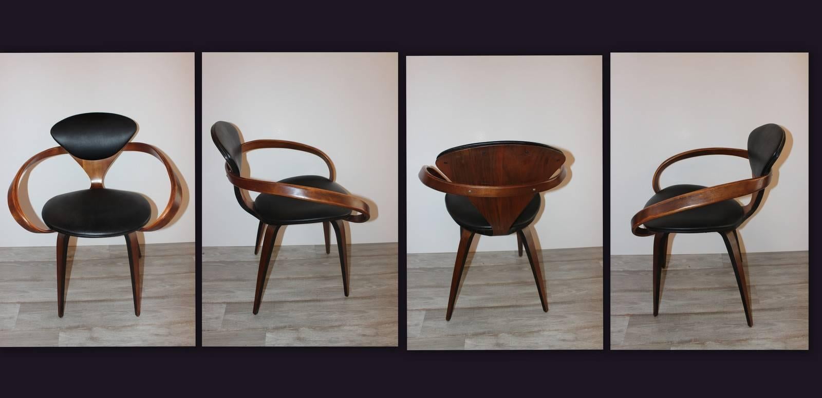 Iconic pair of pretzel chairs designed by Norman Cherner and made by Plycraft. These chairs are identical Both retain the Plycraft labels and dated 1963.
 Laminated walnut construction with black upholstery . 
 These chairs are much more sturdy