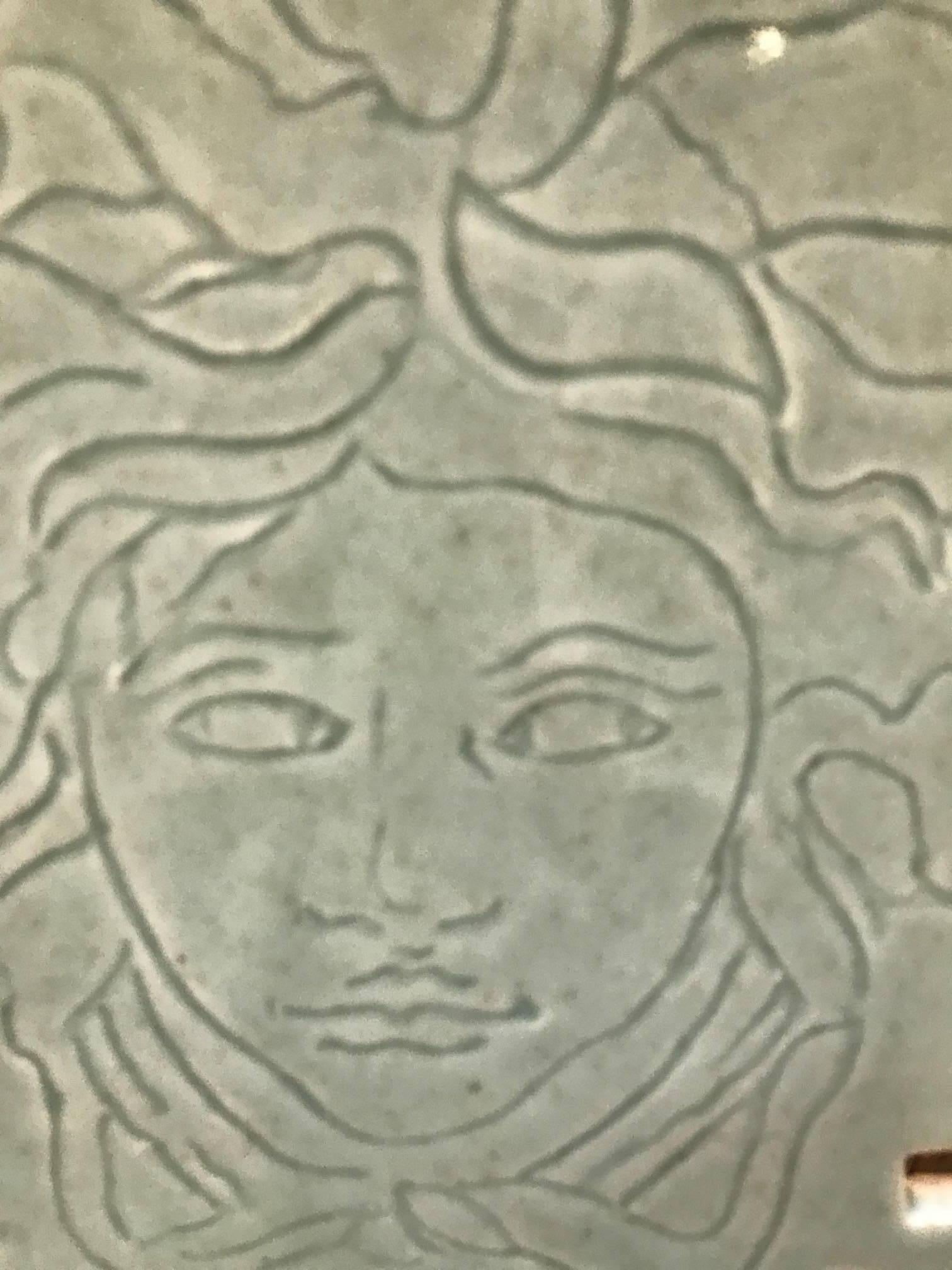 Artist signed porcelain tile depicting Medusa by Ricardo Arango. Inspired by ancient artifacts combining expressionist sculpture and antiquity. Signed on porcelain tile and underside of steel base. The base is 6.75 inches square.

Ricardo Arango