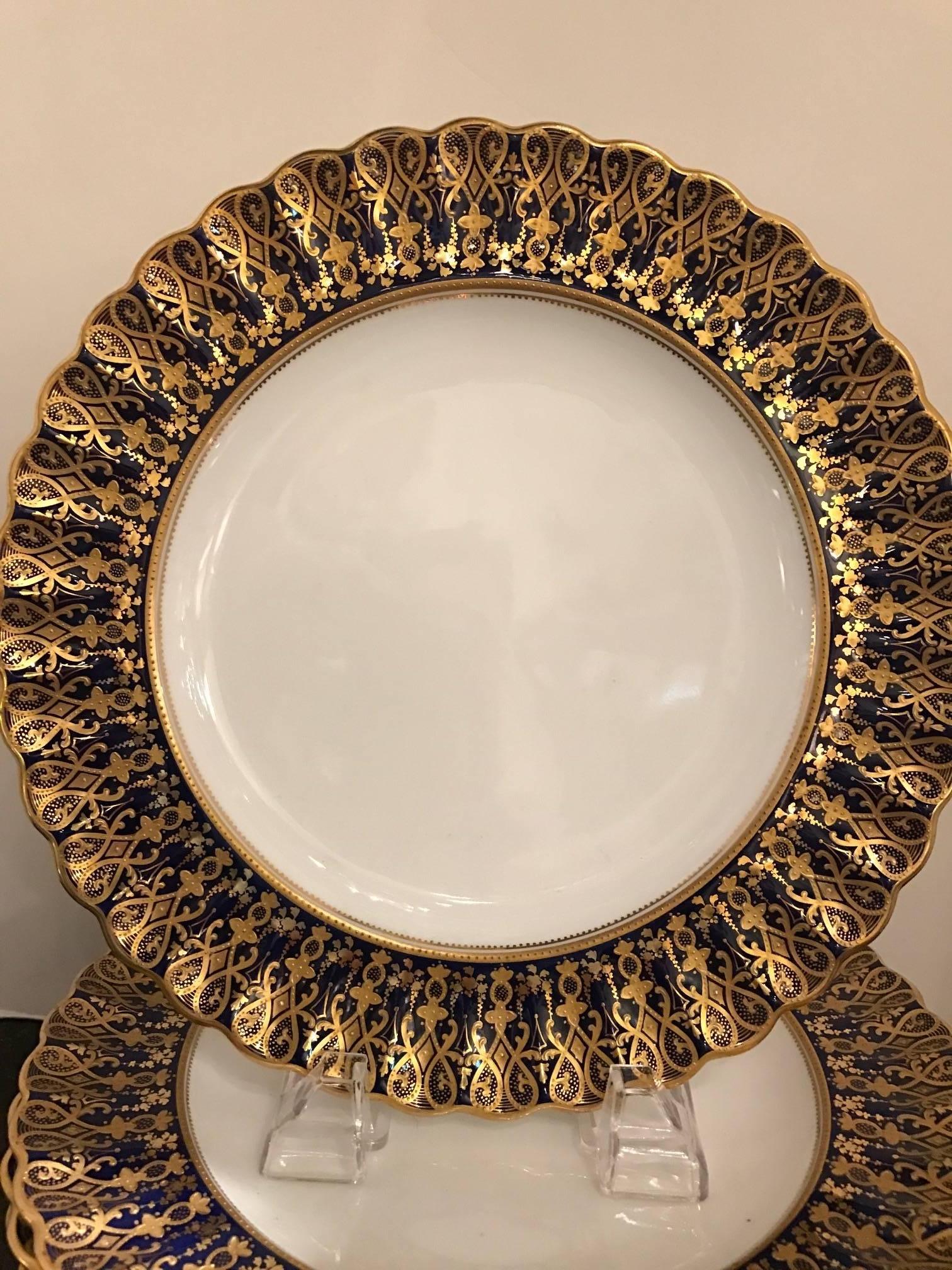 19th century 12 scalloped edge hand painted raised gilt cobalt border plates made in England by Copeland. The elaborate and intricate borders are complacently hand-painted by expert decorators and truly lavish with the gold and deep cobalt blue. The
