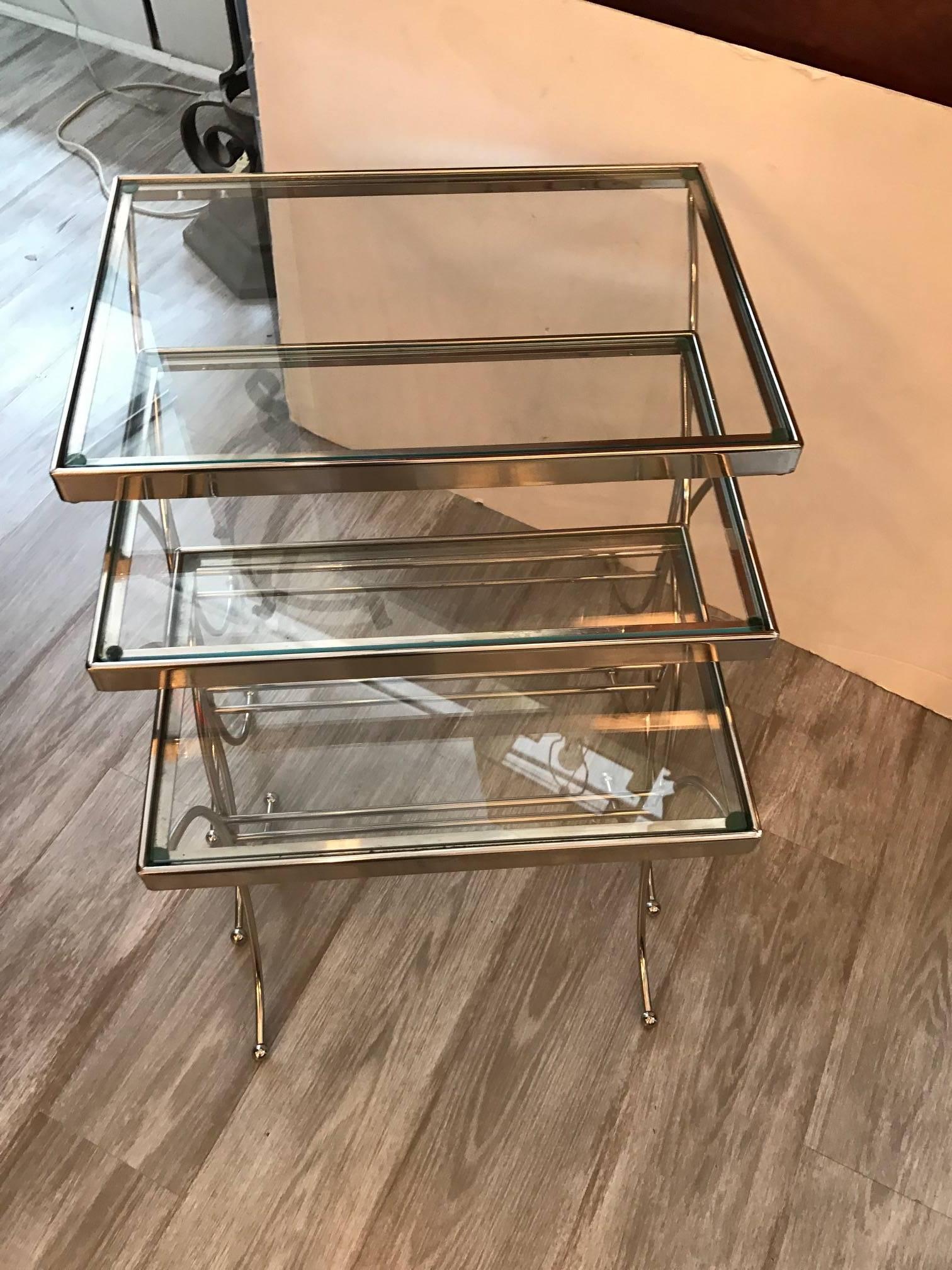 Mid-Century Modern chrome and glass nesting tables. The tables of graduated sizes fit neatly into each other making this great for a small space.