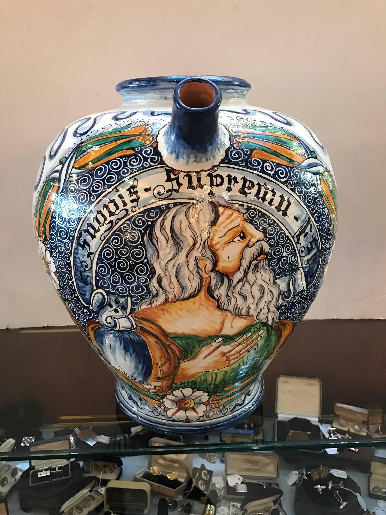 Large and vibrantly hand-painted Italian faience wine jug. The bulbous body with upper spout and nicely detailed handle.
