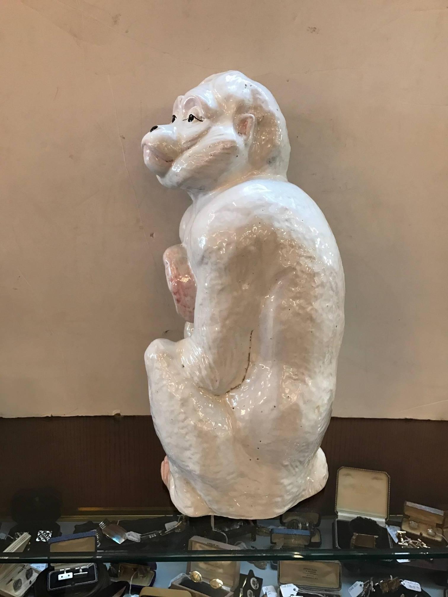 White faience glazed pottery monkey made in Italy. The all white body with flesh tone highlights on the hands and feet with hand-painted face, circa 1960s.