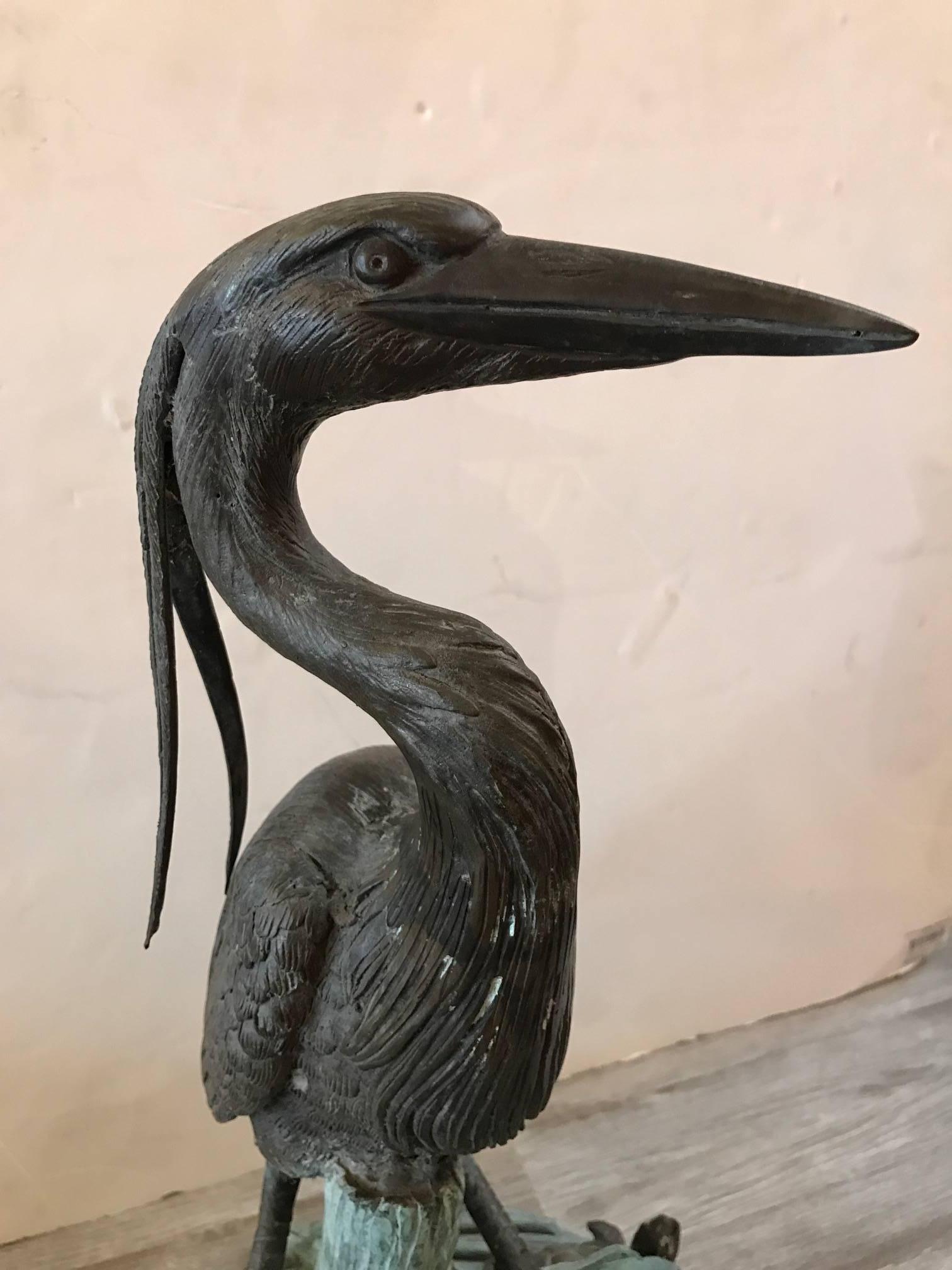 A bronze sculpture with heron, frog and turtle. Signed on base Jim Porter Pafa. The figures are in a weathered brown patination with the base in a weathered green. The water attaches at the base on the bottom with water flowing out the mouth of the