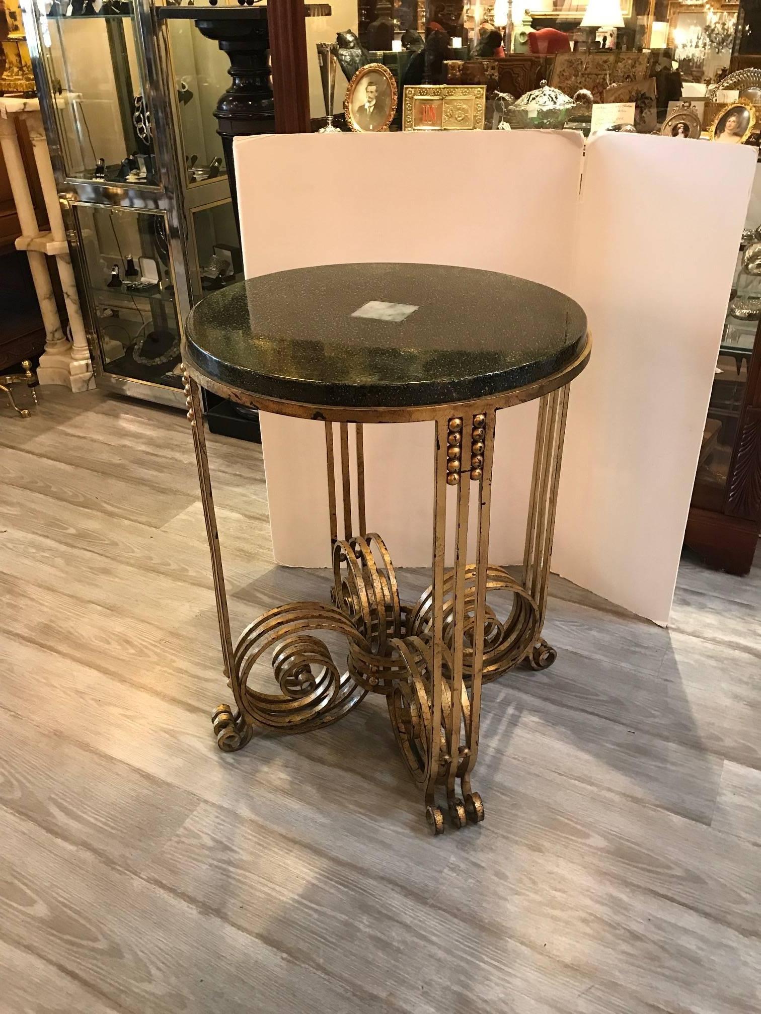 Fabulous French Art Deco gilt wrought iron table with hand-painted lacquer top. The top has a jade tile inset in the centre. The base is a triple layer scroll leg with the original gilding showing expected wear. The top being a multi-color Japanese