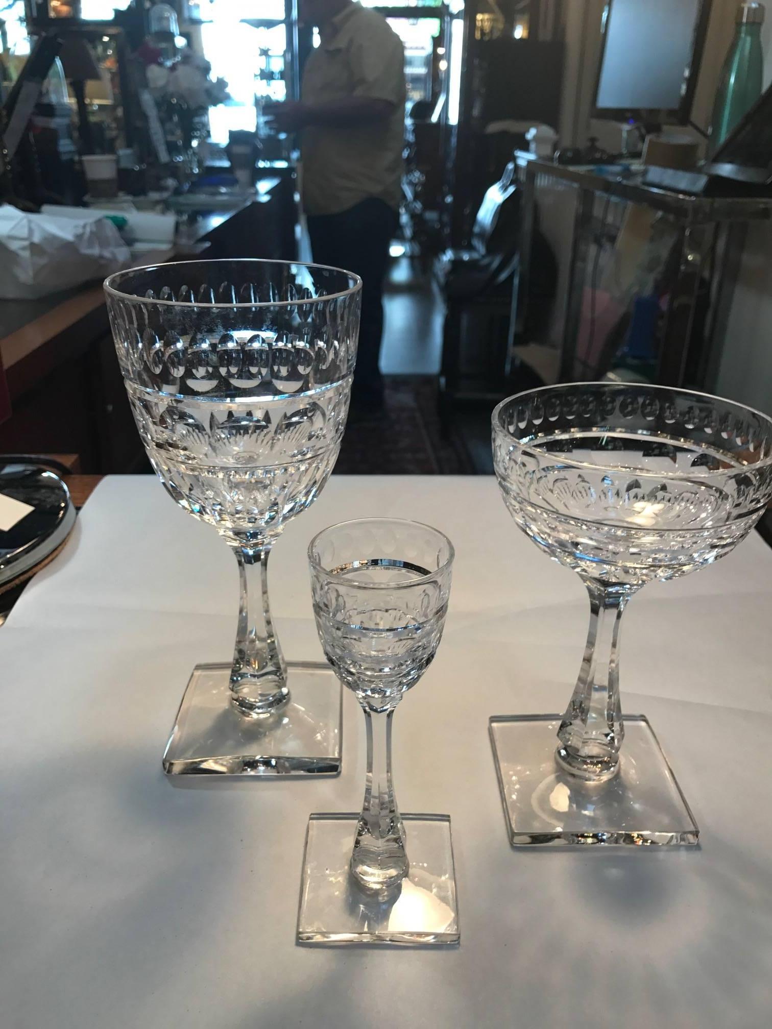 Exceptional and complete set of Hawkes hand cut and polished stemware. 12-7.75 in Wine glasses, 12-6.25 in Coupe Champagnes and 12-5.25 in cordials. All hand made in the early 20th century by the master glass cutters from Hawkes, Corning NY.