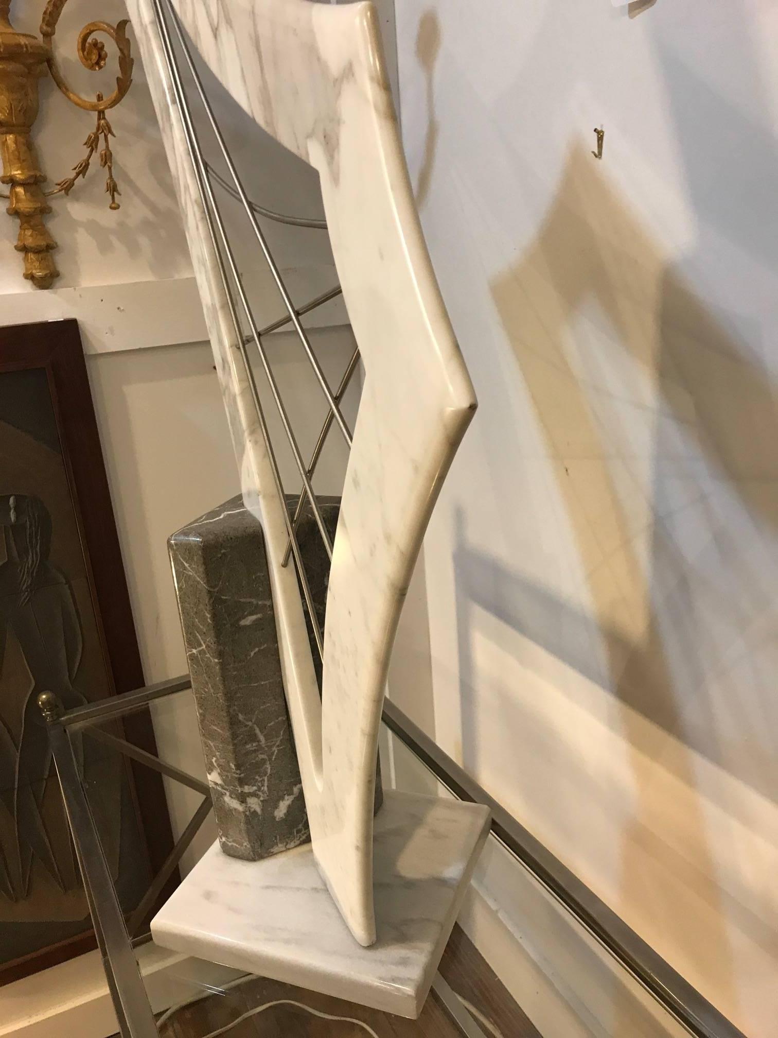 One of a kind artist signed marble sculpture in the form of a harp. The marble harp with steel rods forming the strings, signed L. Ritz 1989 on the black marble base.