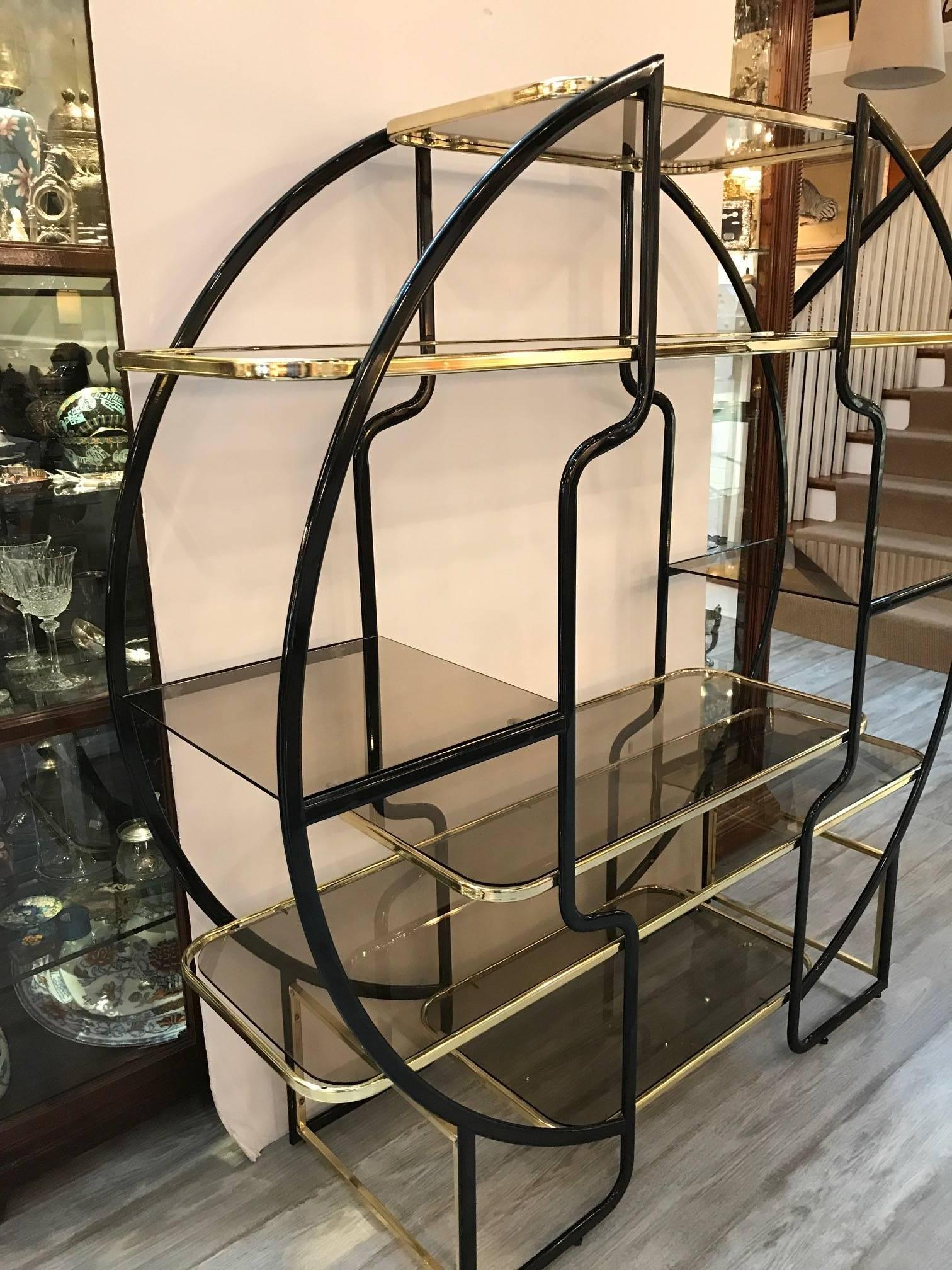High style black enamel and brass étagère with light smoked glass shelves. Great display with lots of shelves, in the manner of Pierre Cardin.