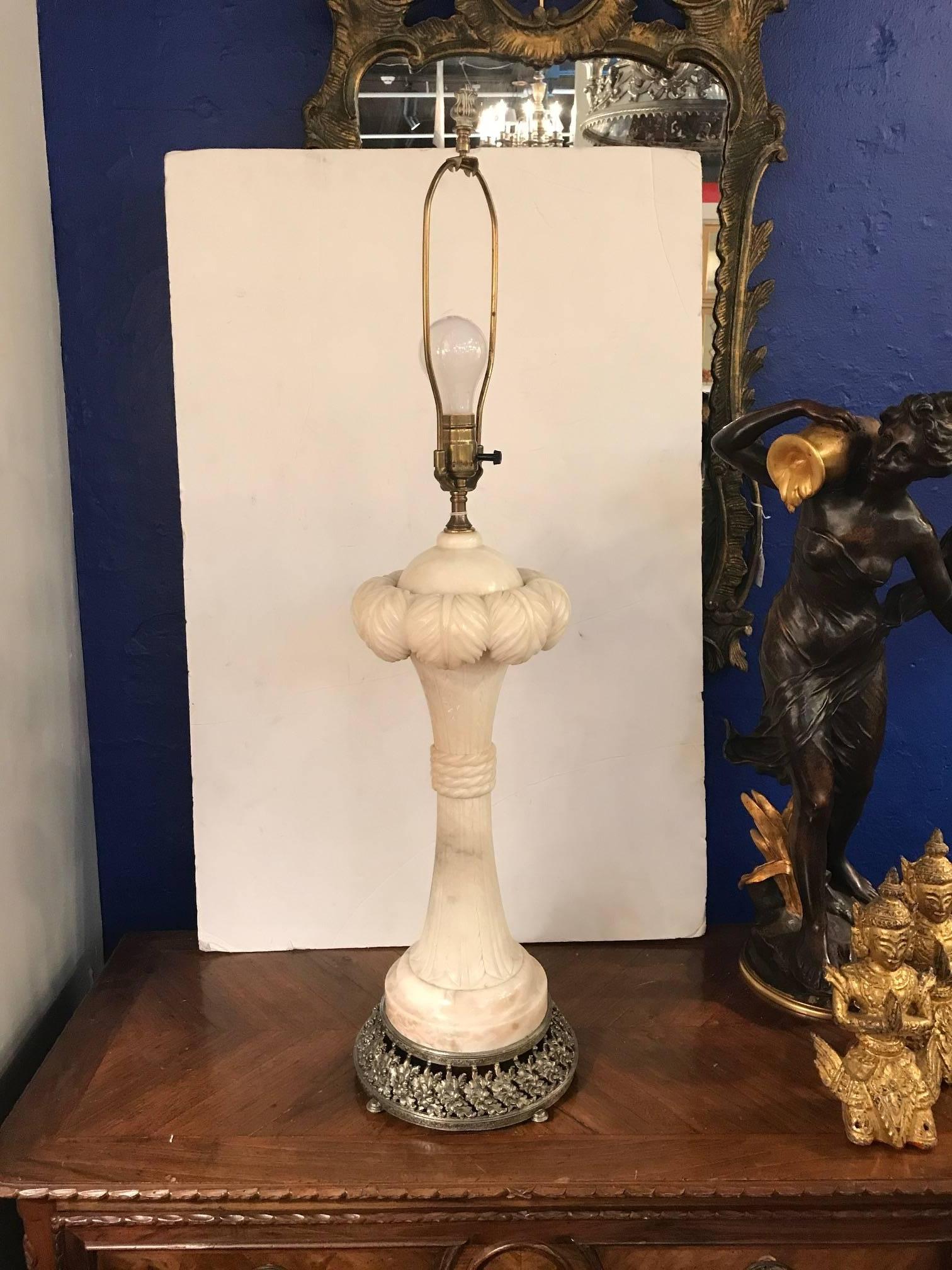 Chic carved alabaster lamp made in France, circa 1920. The plume top with cinched center on flared base. The shade is for photographic purposes and not included with the lamp. 34 inches tall to the top of the shade, can be made taller or shorter