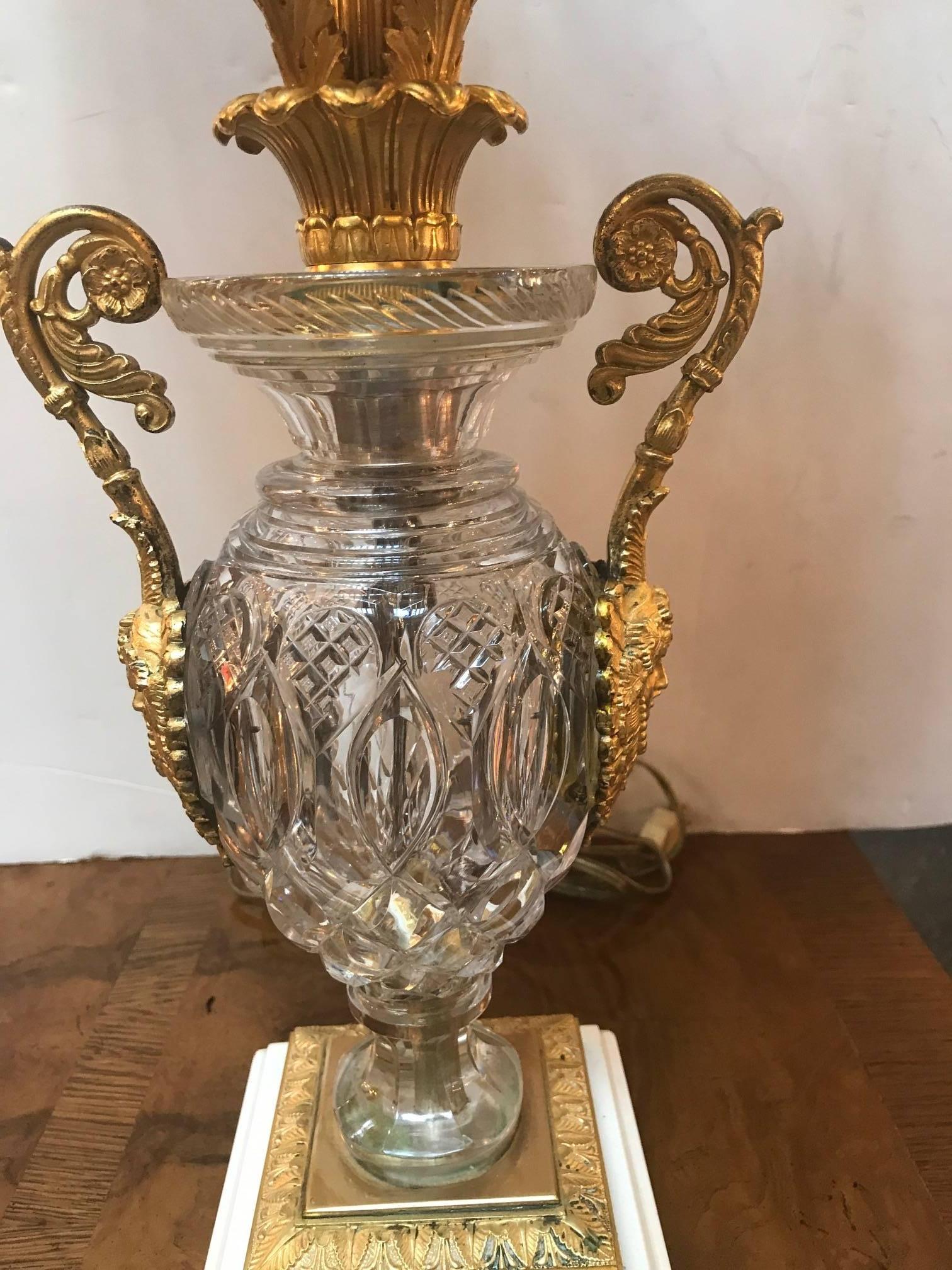 An antique hand-cut crystal and gilt bronze candelabra lamp. The early French Charles X candelabra gilt is original and in excellent condition. The hand-cut urn is attributed to Baccarat and fitted with bronze handles and base with a marble bottom.