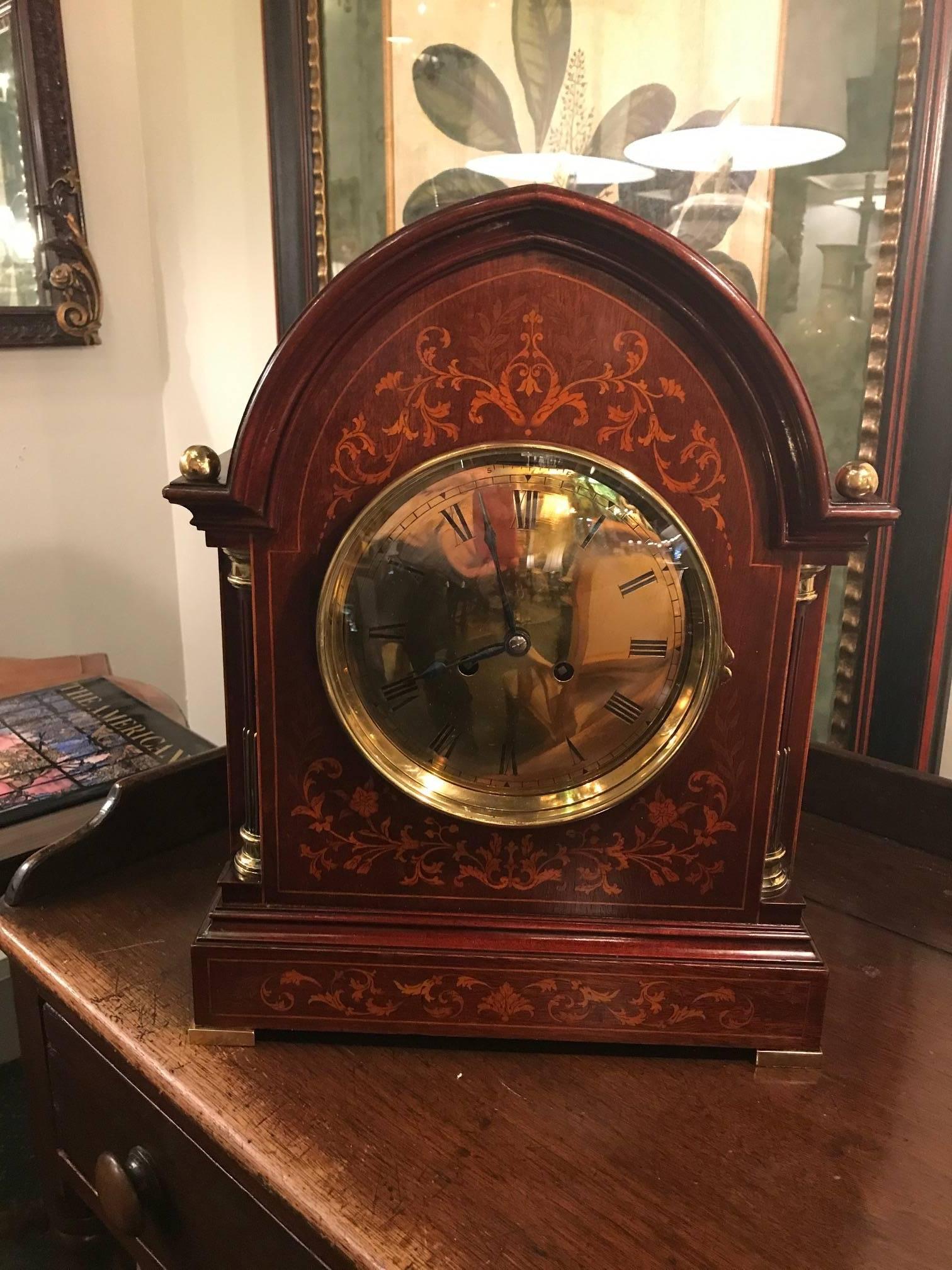 Beautiful mahogany bracket clock with inlay. The brass face with brass accents on the corners and having brass feet and finials. Movement is signed L Courtin 13 jewels. The elegant case is beautifully offset with the bright brass. The clock runs and