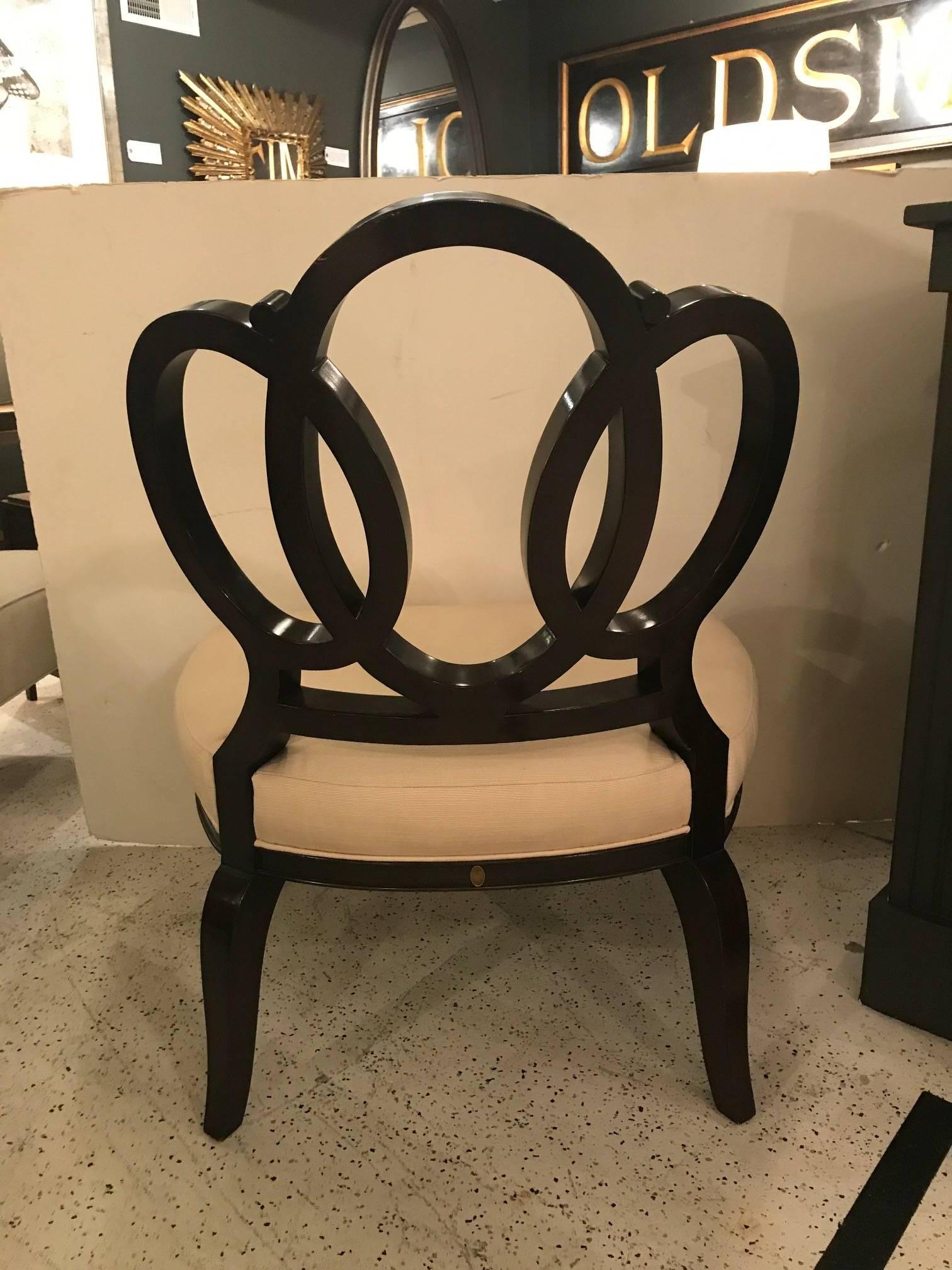The bracelet chair by Barbara Barry speaks for itself: pure elegance and timeless beauty.The bracelet chair was one of a collection of pieces she designed for Henredon. The intelocking ovals that serve as the back are grand and well designed. The