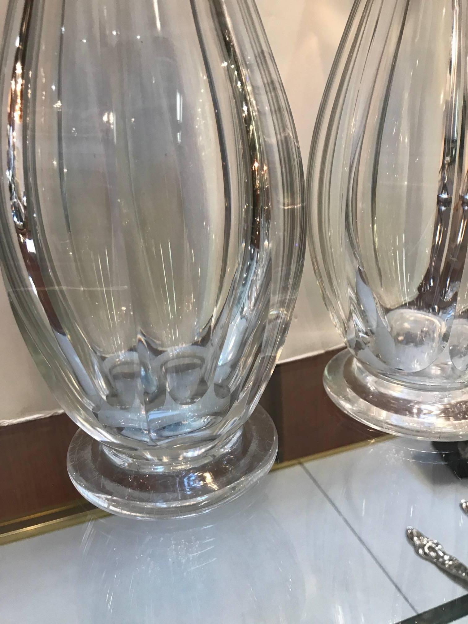 Pair of blown flint glass decanters, circa 1840. The hand-cut panel cut sides topped with multifaceted stoppers. The bottoms have a polished pontil showing these were hand made by an expert glass blower and cutter.
Flint glass refers to glass made