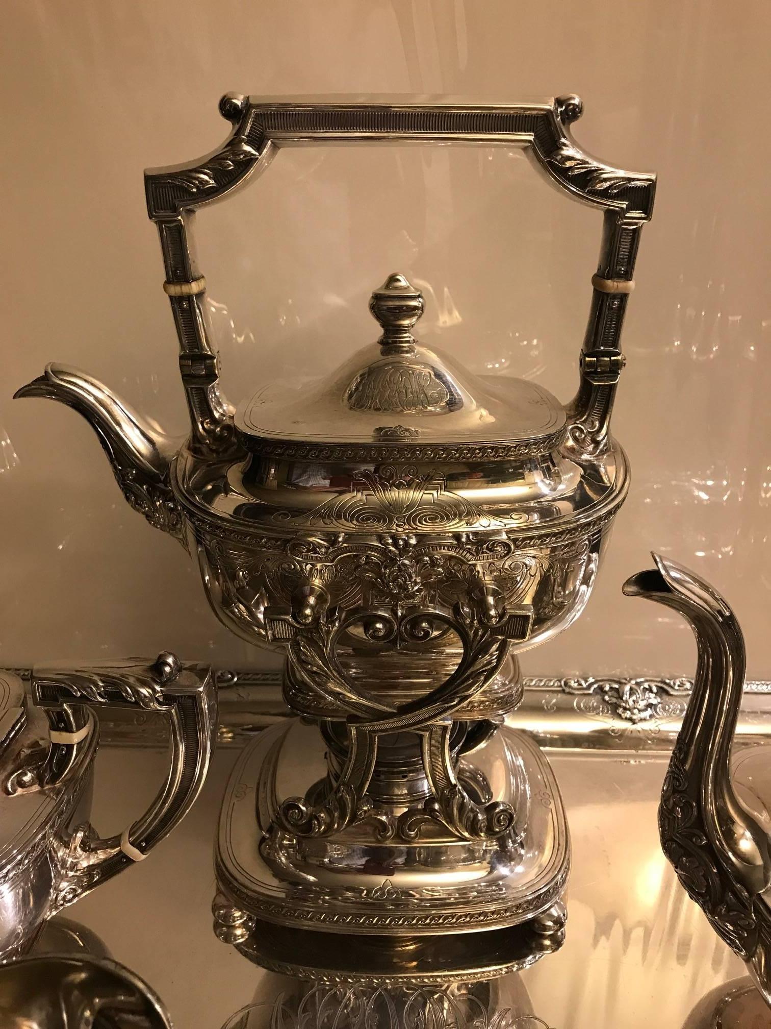 Exceptional hand chased tea set by Gorham, year mark 1925. Set includes, all in gleaming heavy silver plate, large tray, large tilting kettle, coffee pot, tea pot, covered sugar, creamer This elegant set is very complete and all original with