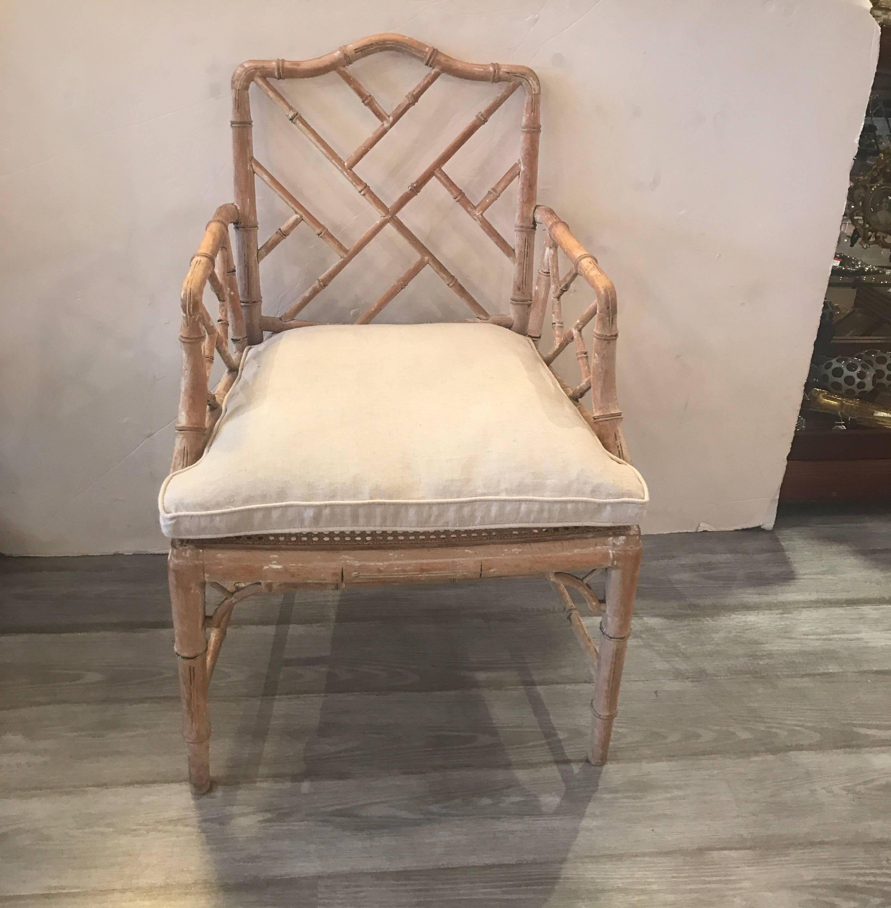 A high style pair of carved maple bamboo motif Chinese Chippendale armchairs. The scrubbed finish with new linen seat cushion. The seats under the cushion is caned and in excellent condition.