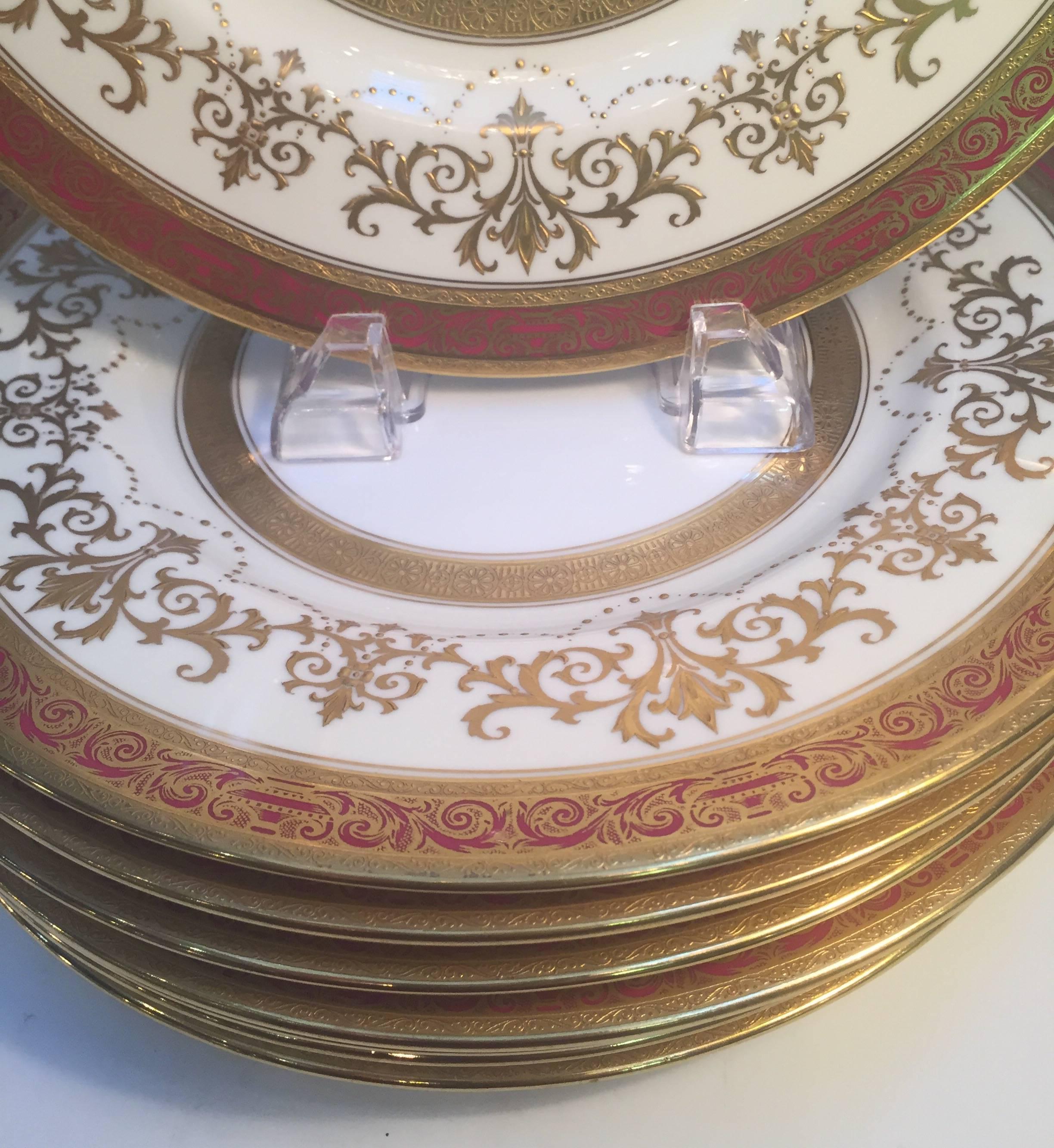 Elegant Edwardian service plates with raised gilt borders. The gold borders with burgundy band and gold inner band marked on back, Minton, the mark places the years to circa 1905. Measures: 10.5 inch diameter.