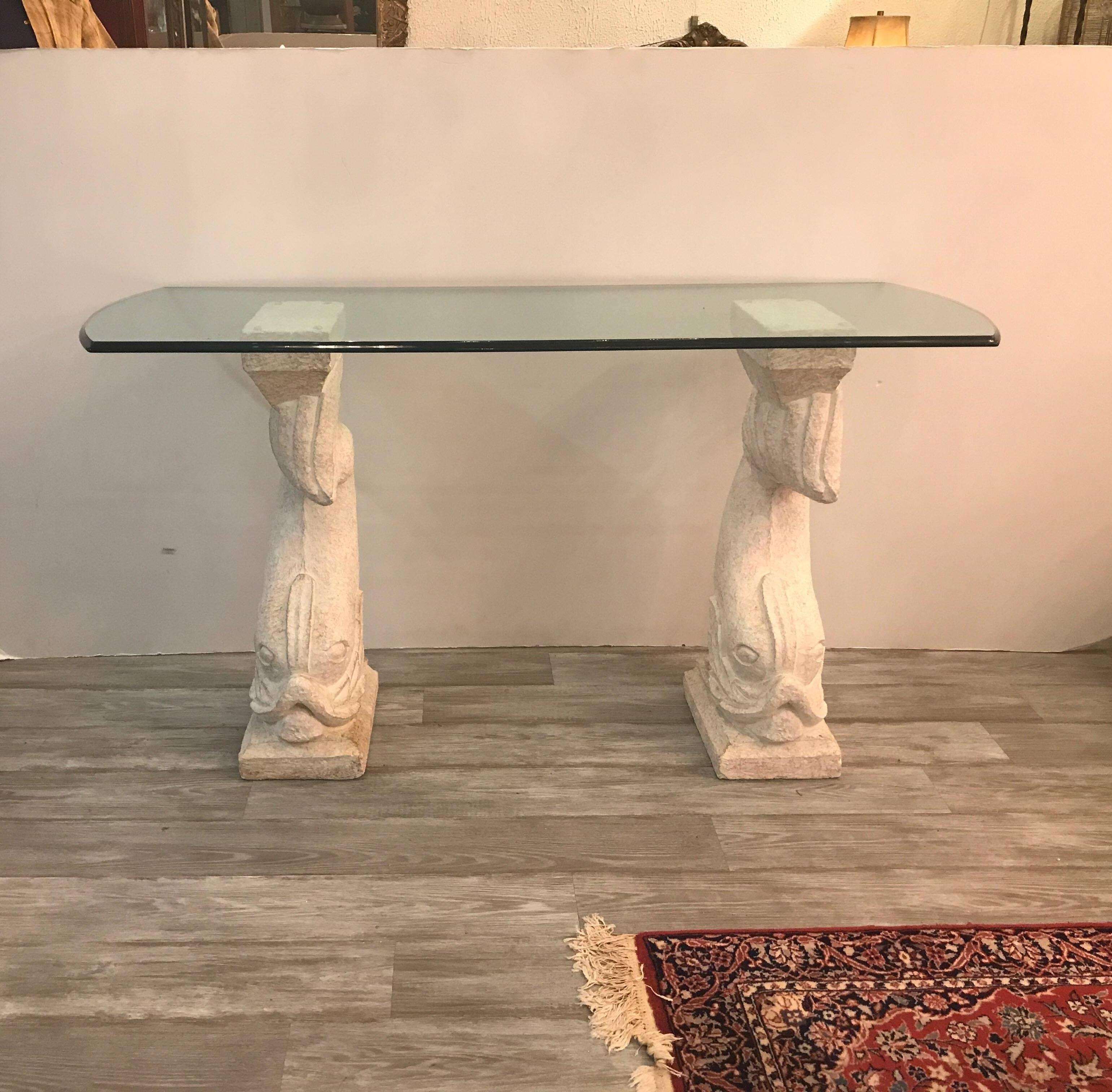 Whimsical dolphin motif console table.  The two cultured stone bases with a stippled finish supporting a thick ogee edge top.  The bases can be repainted. 