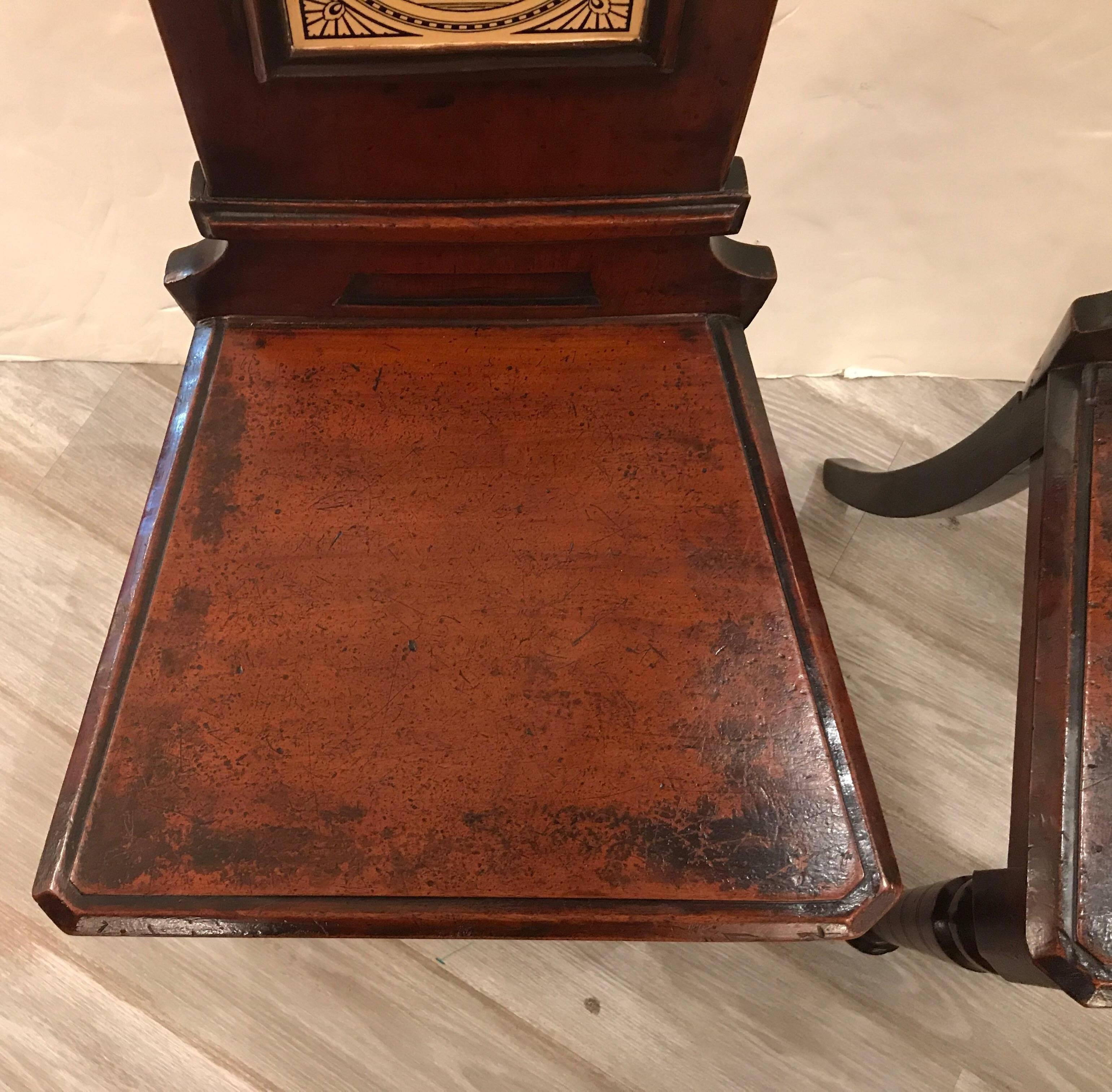 A pair of 19th Century English hall chairs with Minton Tiles 1