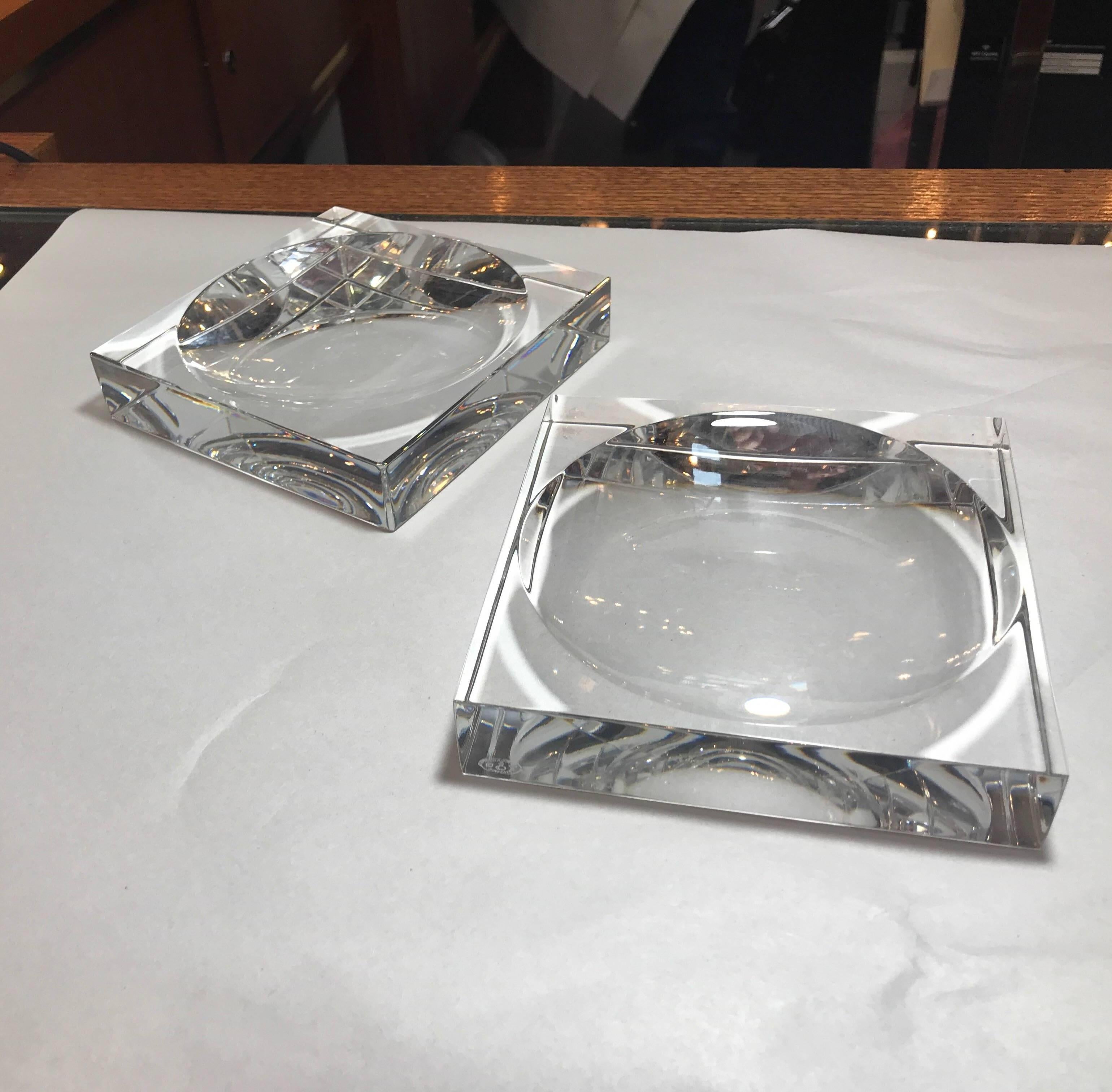 A pair of chic high style signed Baccarat square dishes with a simple concave centre. Each on is marked with the authentic Baccarat mark.