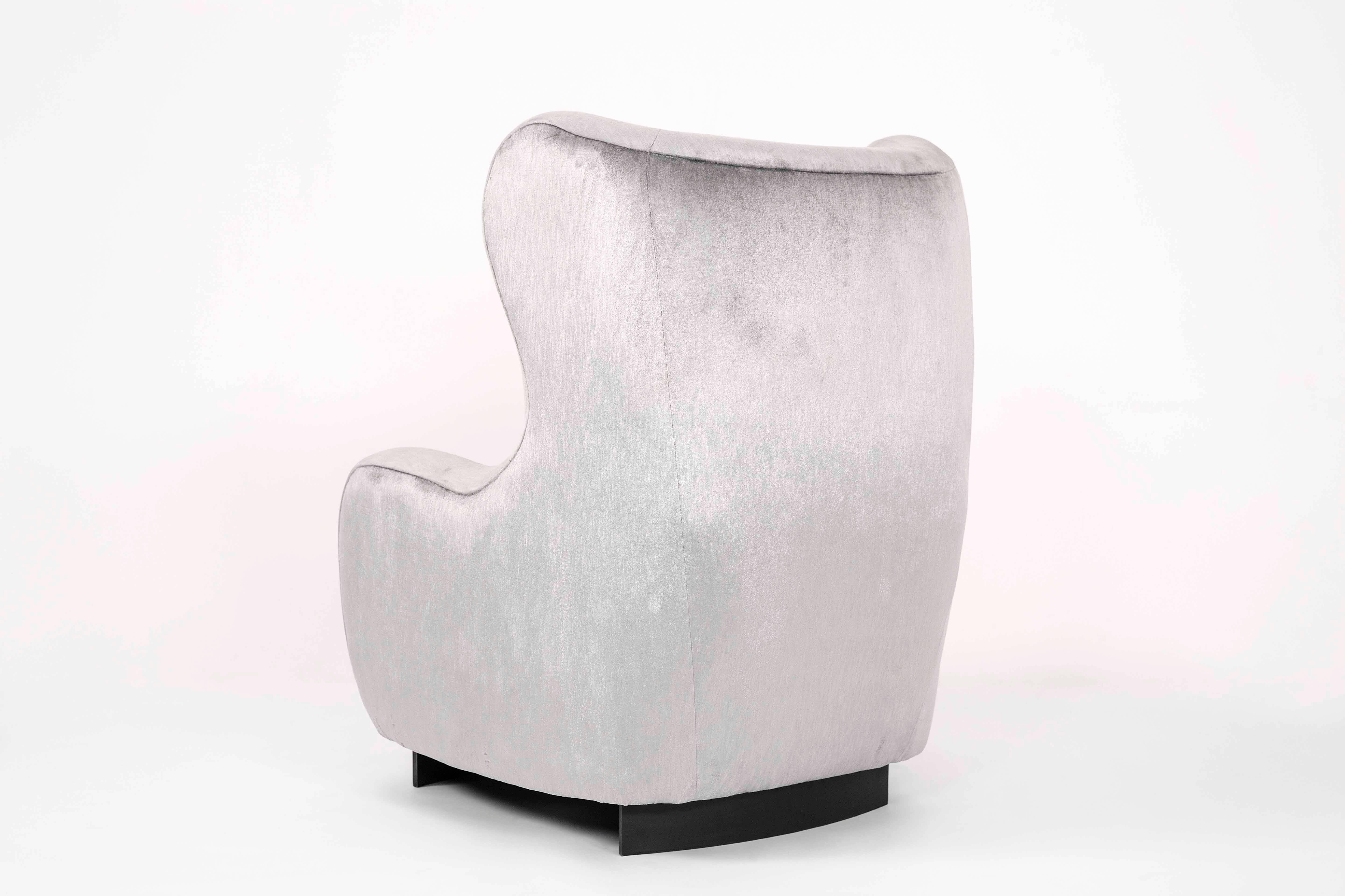 The Corbridge armchair is an oversized statement piece, solid and protective yet elegant and curved. Designed to give the user the feeling of being enveloped in comfort, the chair both feminine in shape but masculine in size. Corbridge refers to the