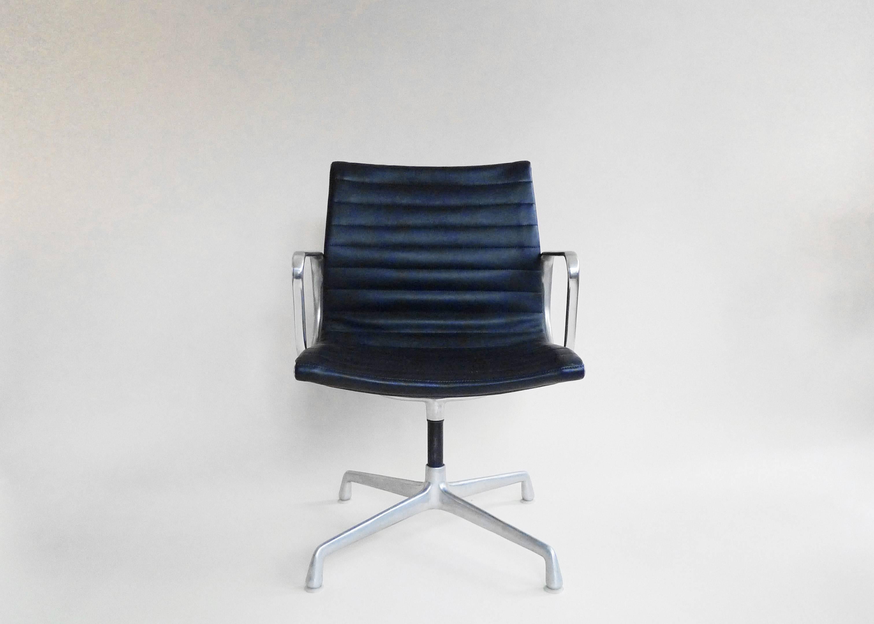 A set of four eames aluminum group chairs, original from an office building in Catskill, NY. Four star base with aluminum and black upholstery in very good condition. Cast Herman Miller imprint on each chair.