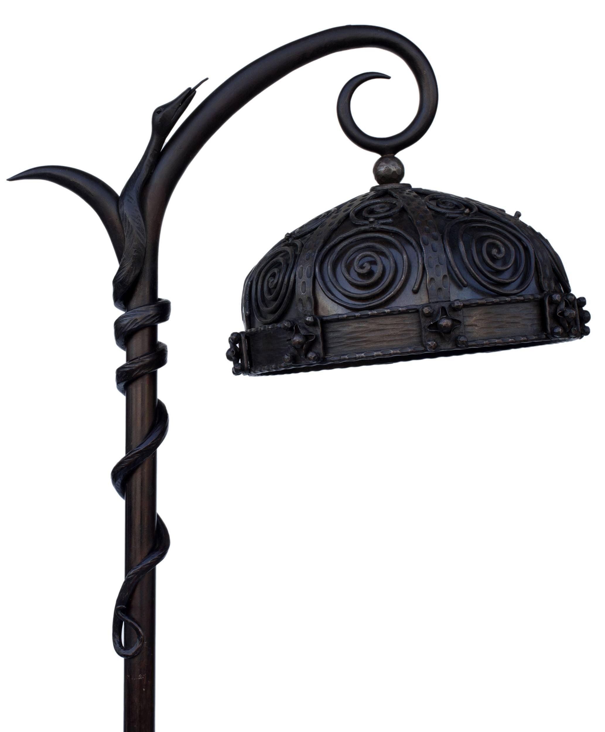 circa 1930 French Art Deco wrought-iron floor lamp. Applied scrollwork shade, the stem applied with a coiling snake, with another snake rising from the square beaded base. Exquisite piece. Provenance: renowned Interior designer Alberto Pinto. The