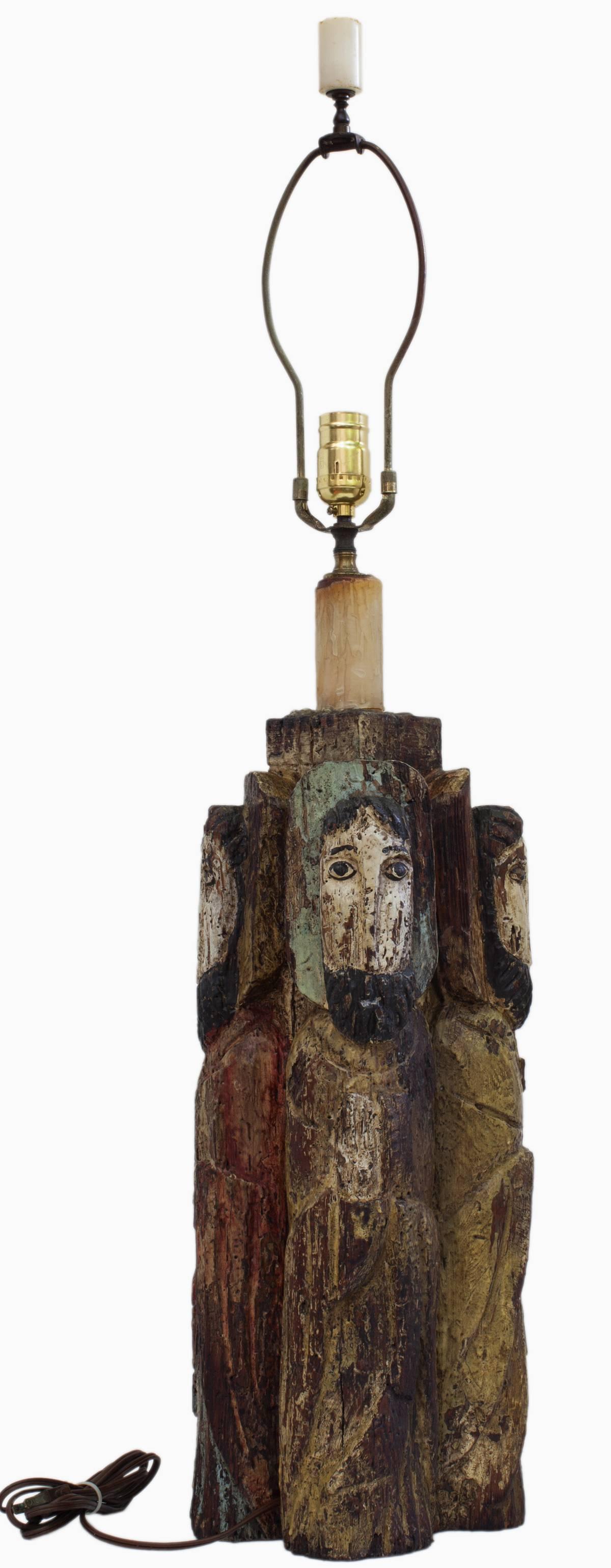Very interesting, Spanish Colonial style hand carved and painted wood lamp having four Bultos figures, one holding a key, likely St Peter, another is beardless and holds a staff. By an unknown Santero, c. 1950.