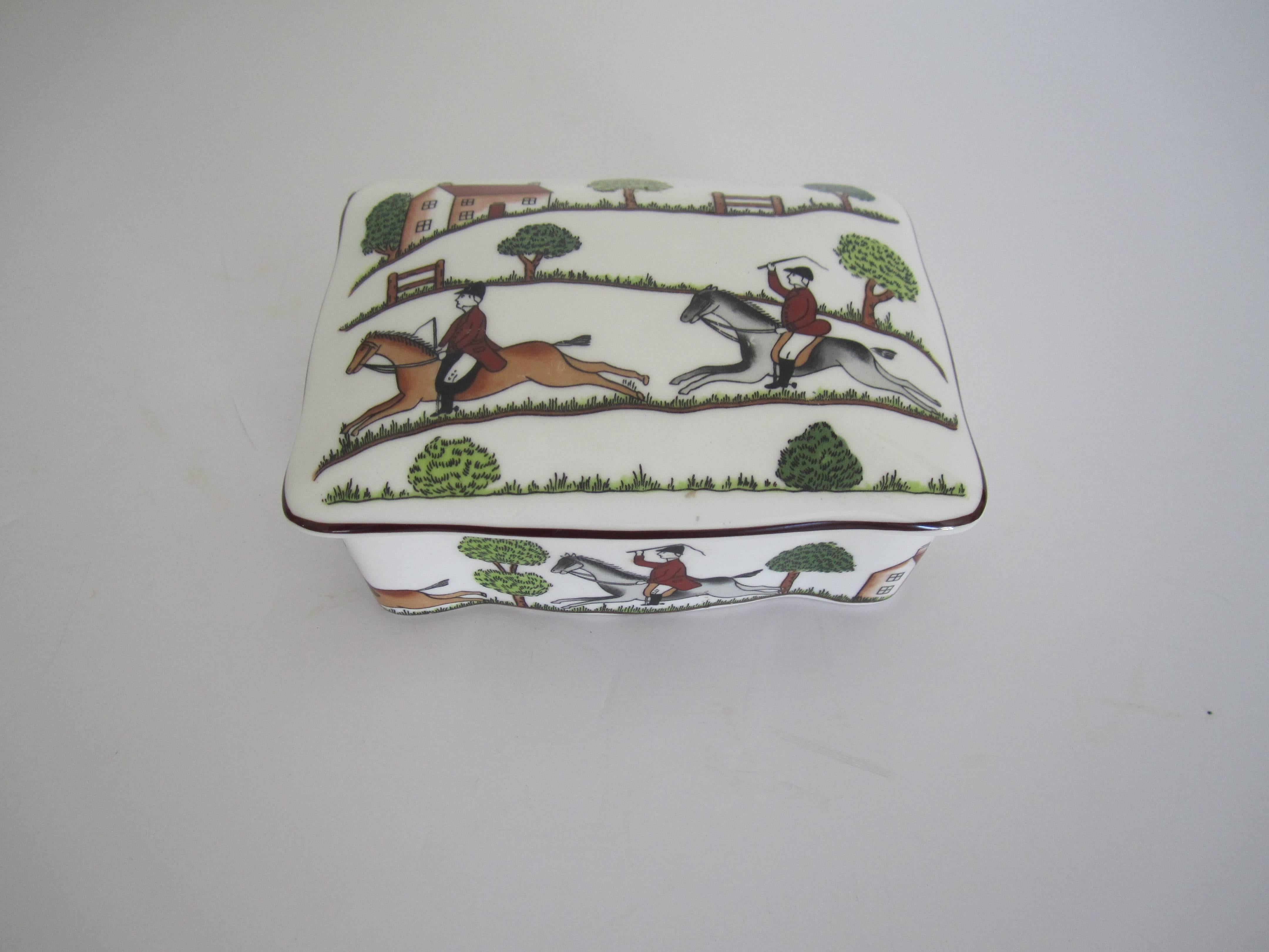 An beautiful equestrian horse 'hunting scene' porcelain decorative, jewelry, or trinket box called 'the chase', in the style of Hermès. Box is from England, with marker's mark as show in image #6. Hues include emerald green, light green, browns,