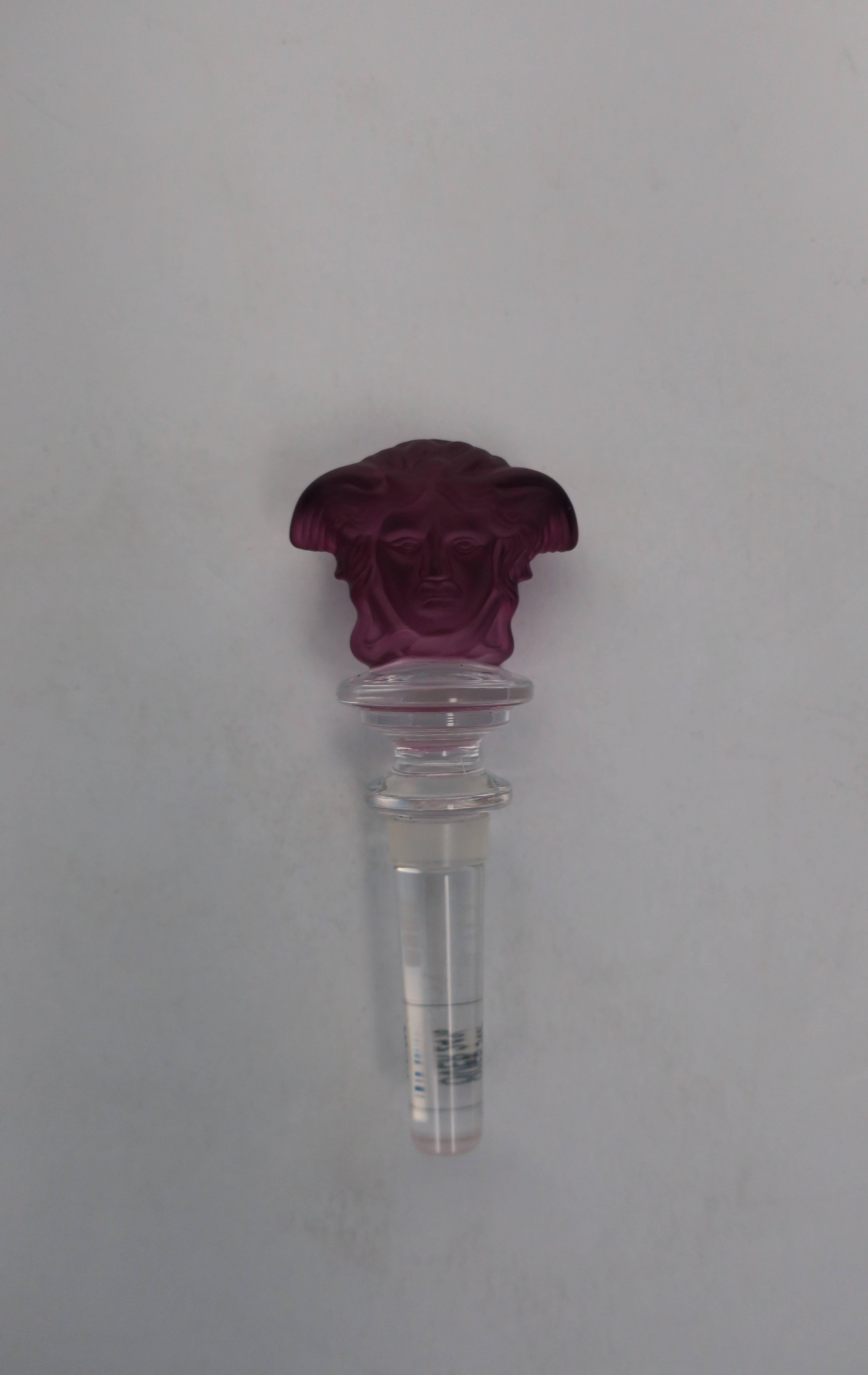 A beautiful Versace 'medusa' purple amethyst crystal wine stopper, in original box; Made by Rosenthal for Versace Home Collection. Medusa head is on both sides. With maker's marks: 