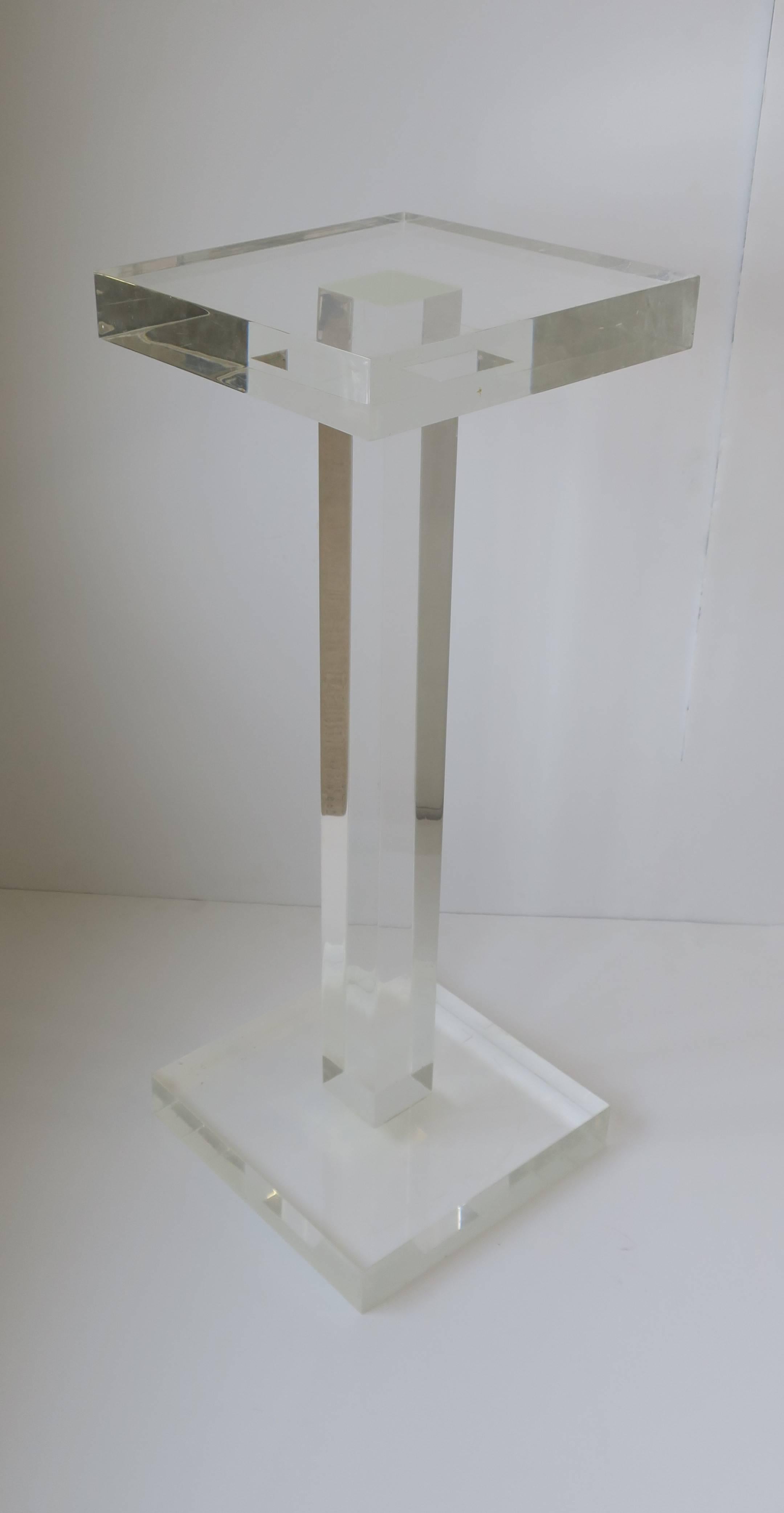 A substantial square Modern style Lucite pedestal or column stand.

Measurements include: 
Pedestal is 32